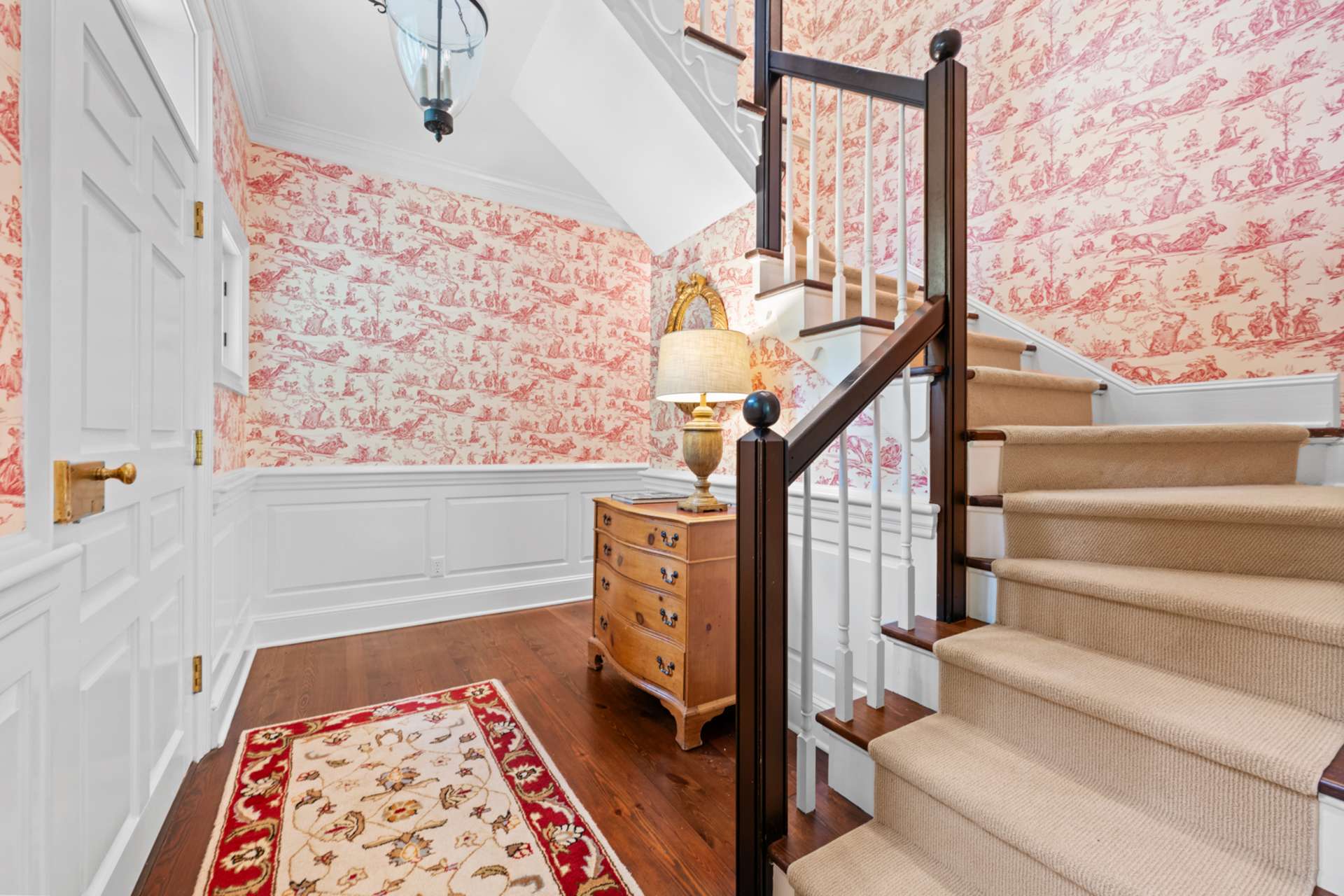 The foyer gracefully leads to the home’s upper level.