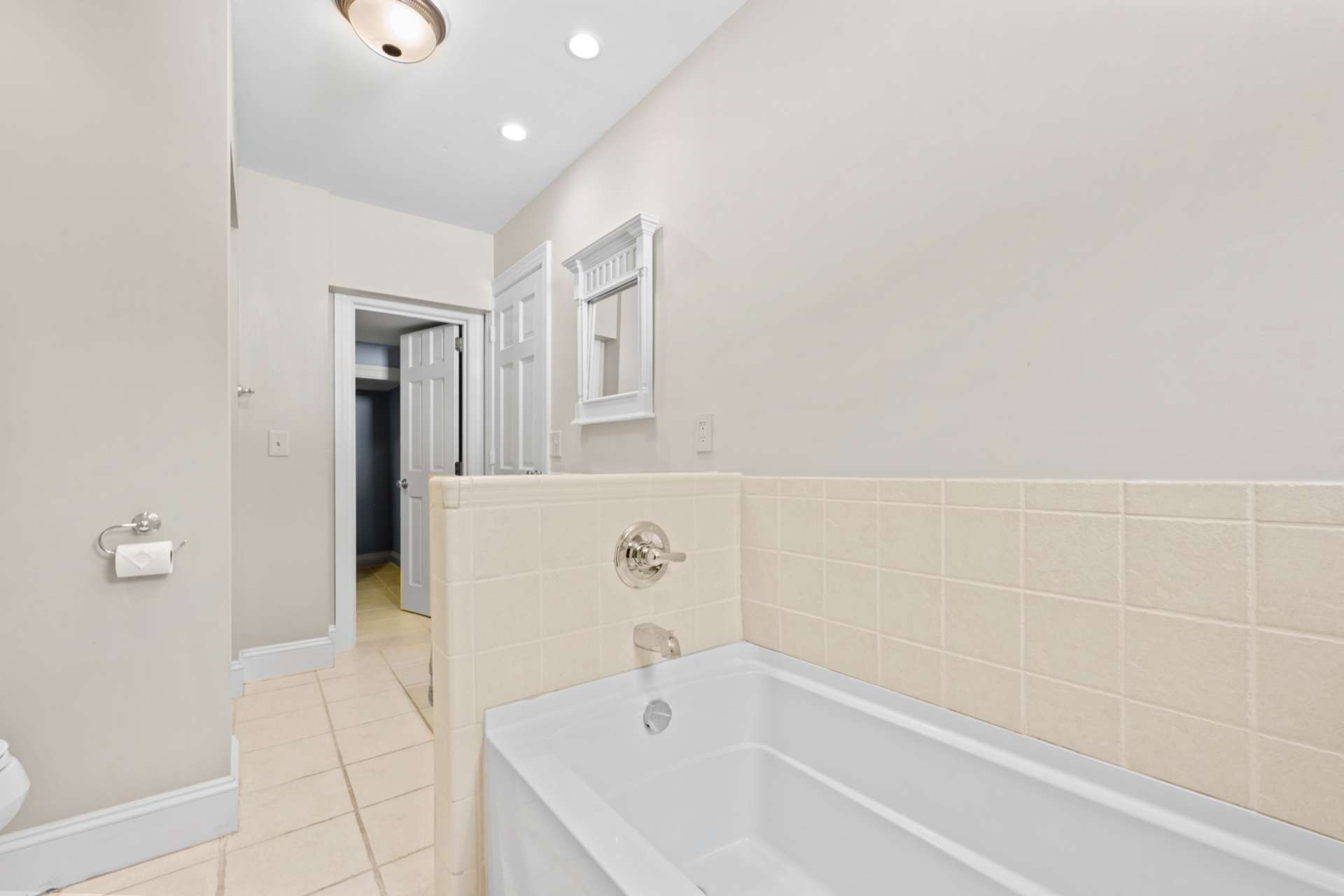 A deep soaking tub adds a spa-like touch to this elegant bath.