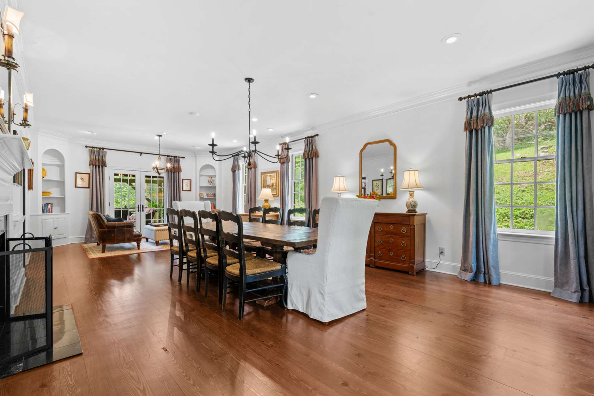 The formal dining room, with dual access and a welcoming fireplace, offers a warm backdrop for memorable meals.