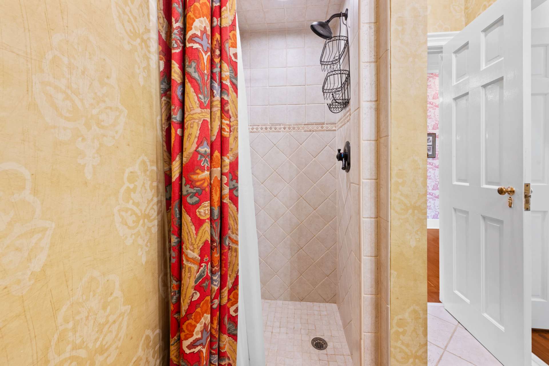 A low-threshold tiled shower provides both style and accessibility for guests.