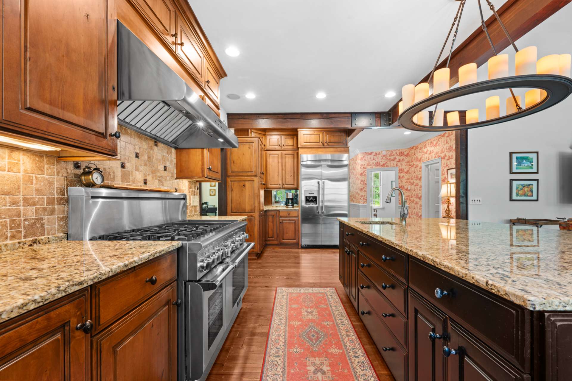 Designed for entertaining, the chef’s kitchen features granite countertops and thoughtful custom touches throughout.