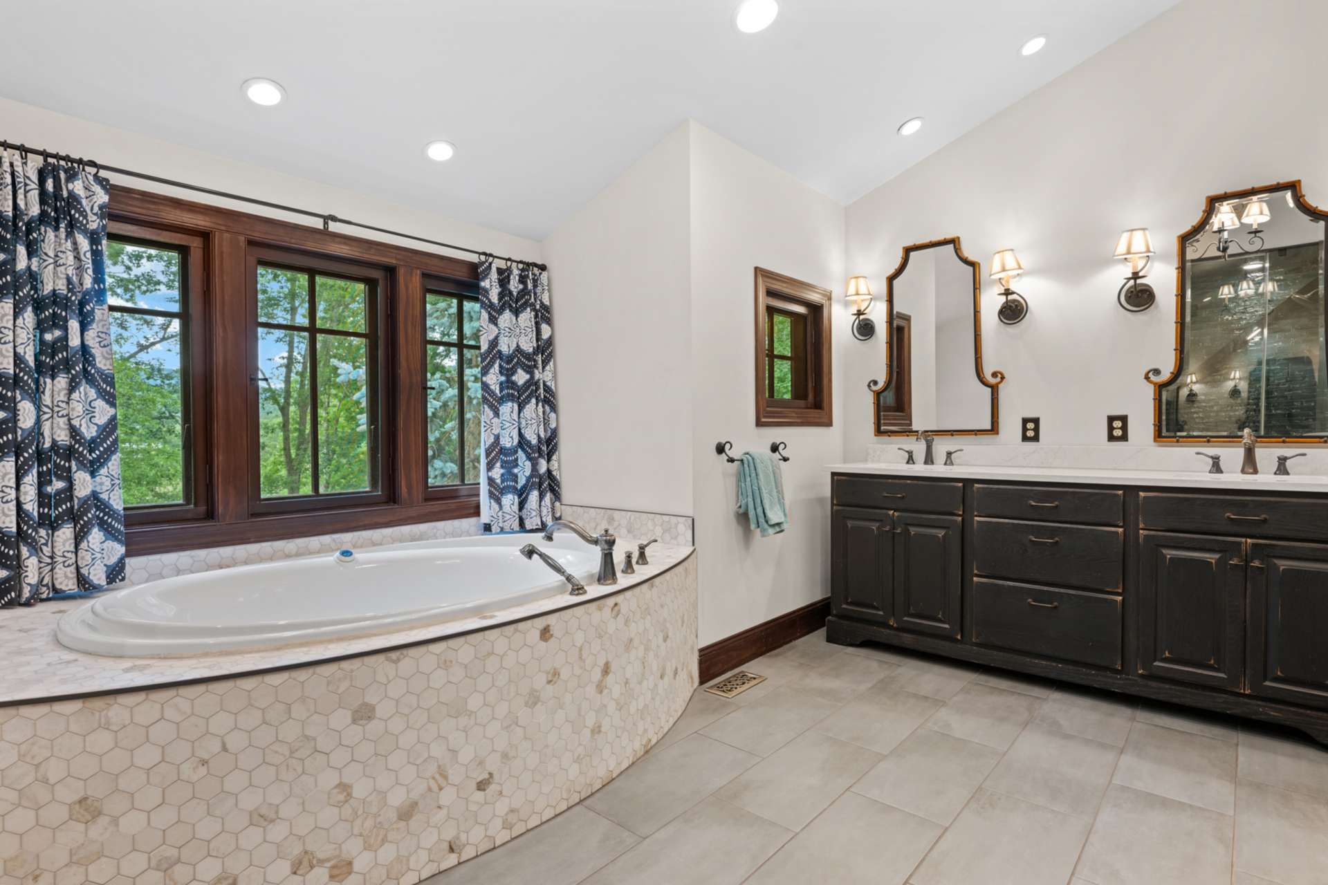 Indulge in the ensuite bath with radiant heated floors, a soaking tub framed by a view, and dual sinks for daily ease.