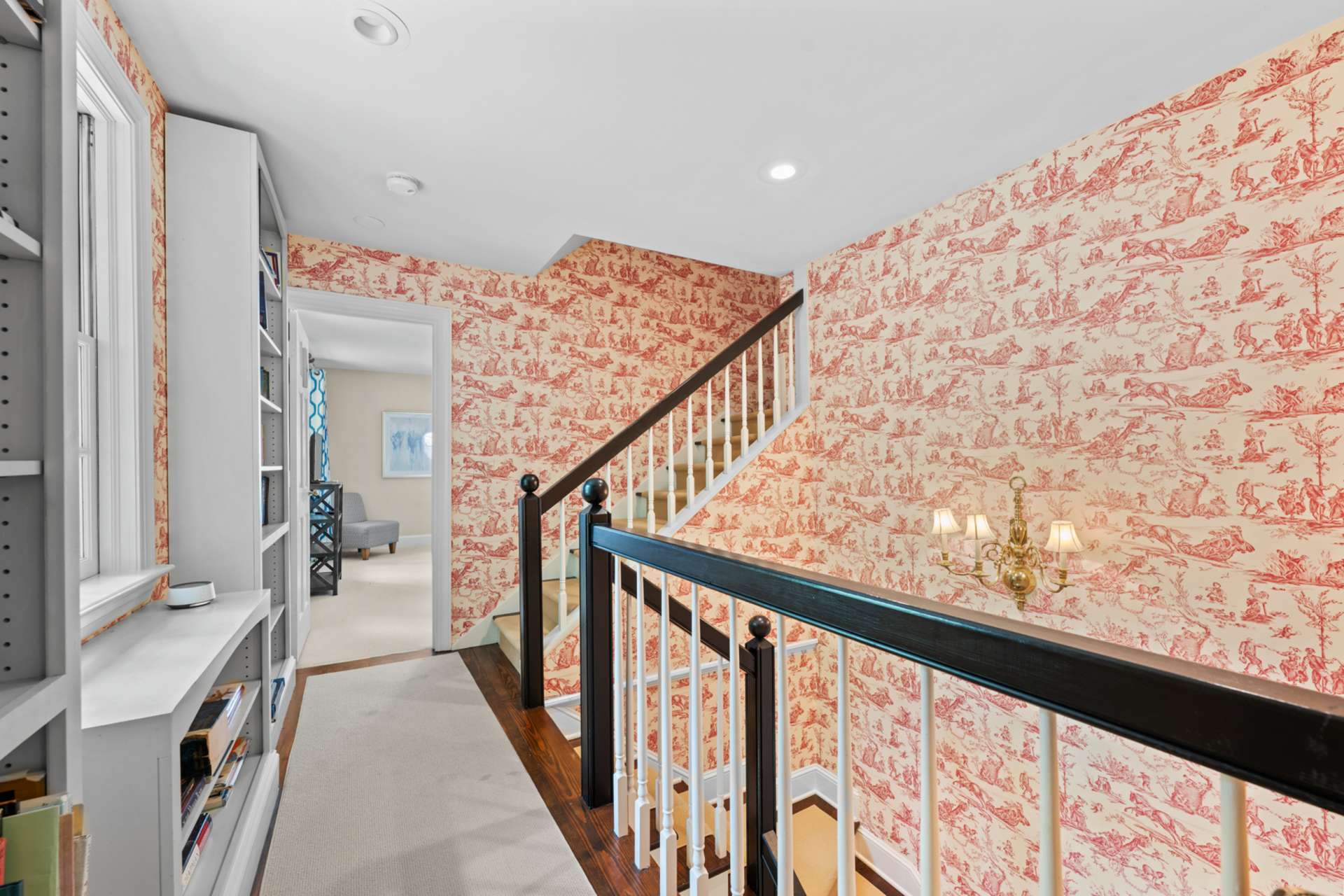 The shared hallway landing offers shelving to display and share your favorite reads or collectibles.