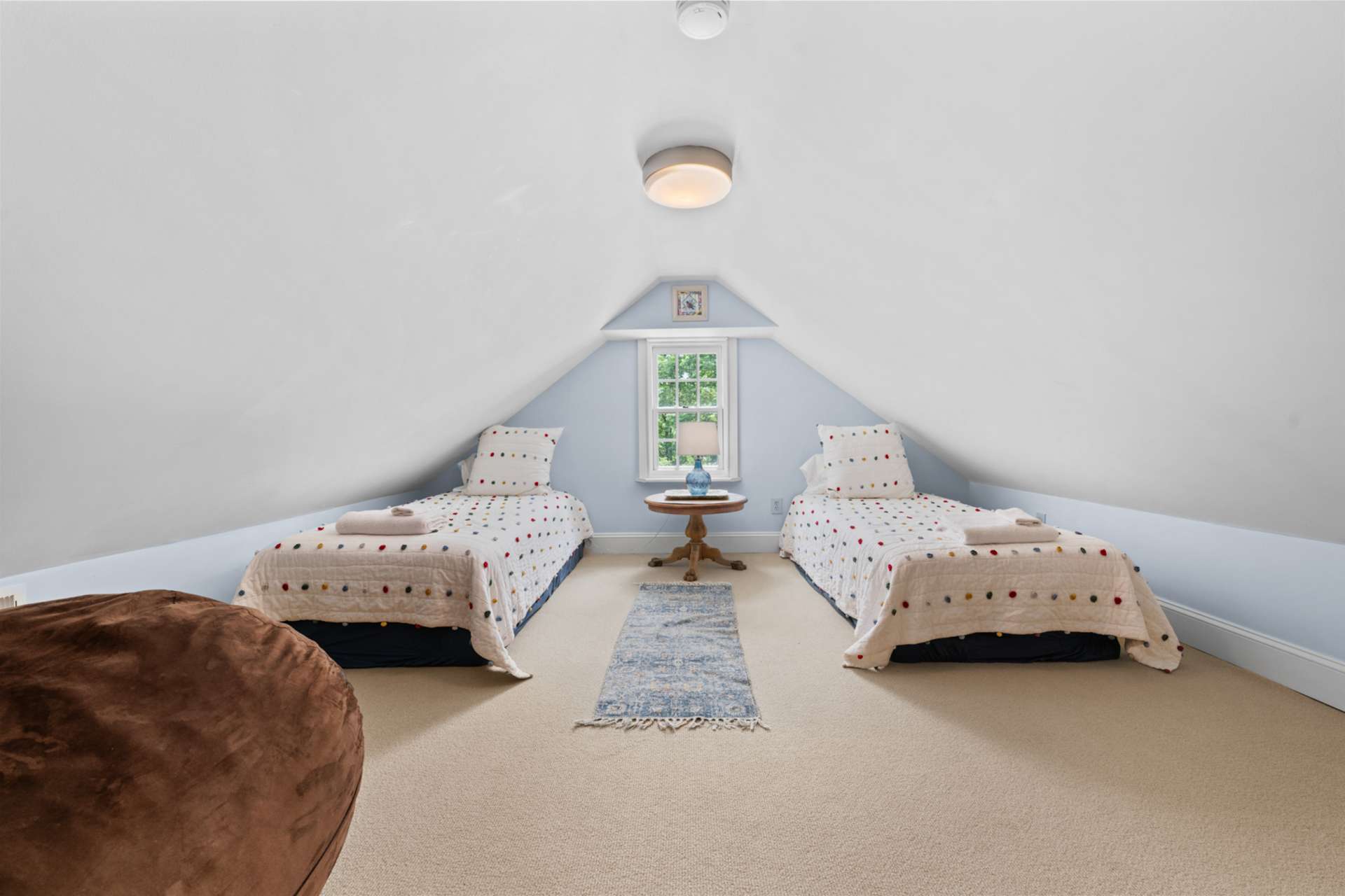 Perched privately above, the bonus room adapts effortlessly as a bedroom, workspace, or personal sanctuary.