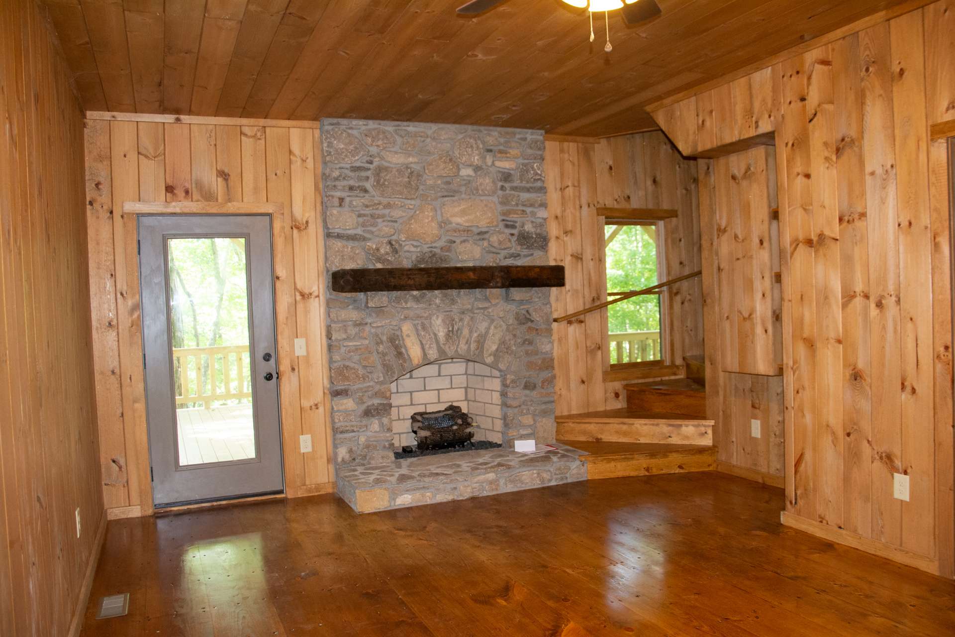 The lower level will provide a den area featuring the second stone fireplace with gas logs, bedroom, full bath, laundry area, and lower level deck.