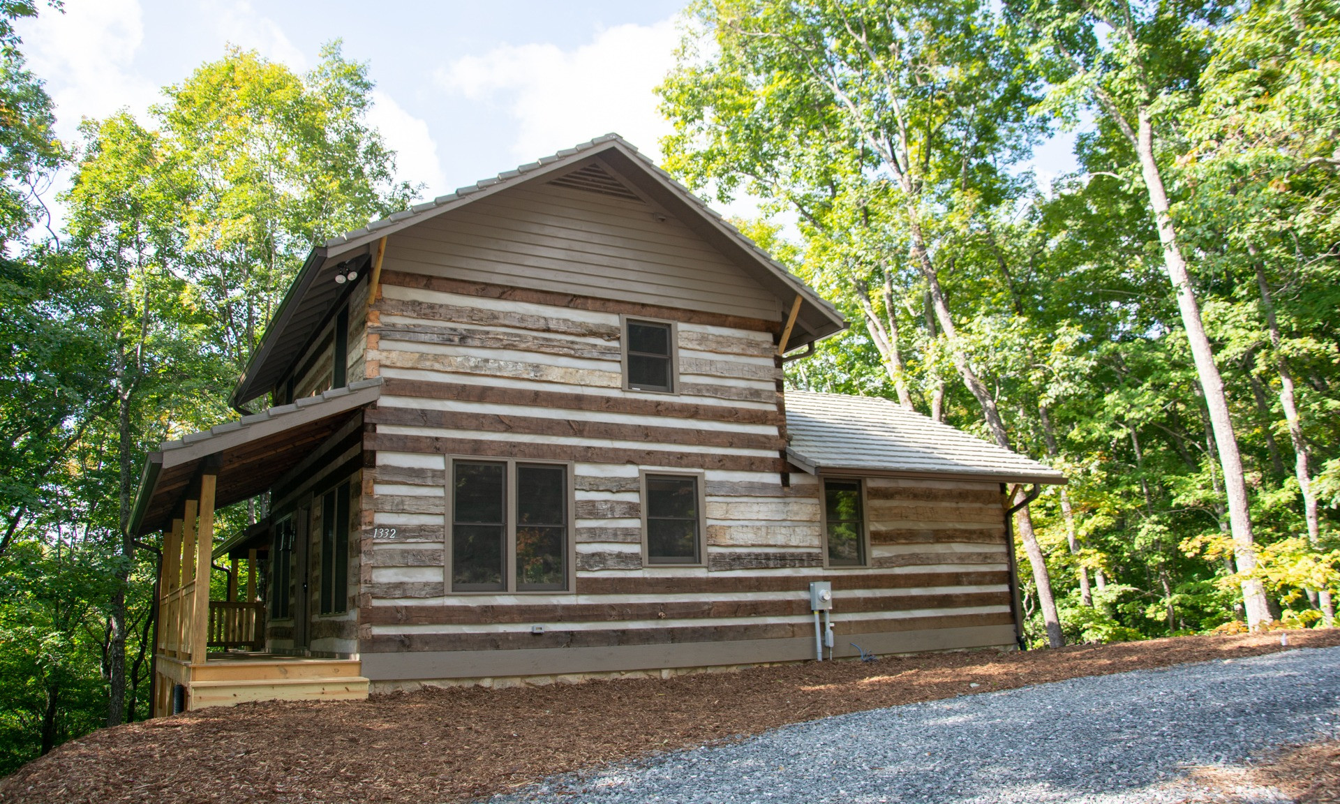 Log Cabin in the Woods! The setting is perfect for those looking to spend leisurely afternoon relaxing on the back deck enjoying the sounds of Nature and the surrounding woodland forest.
