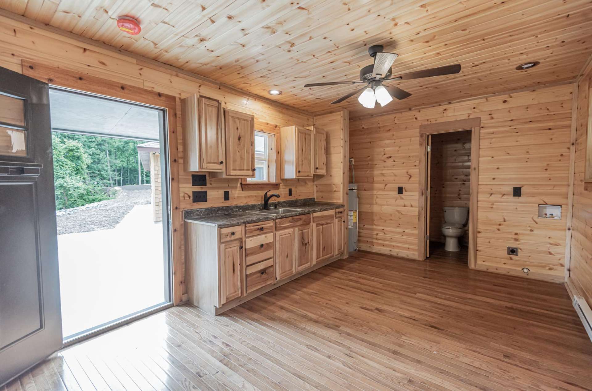 Guest house features hickory cabinets, washer and dryer hookup and tiled shower.