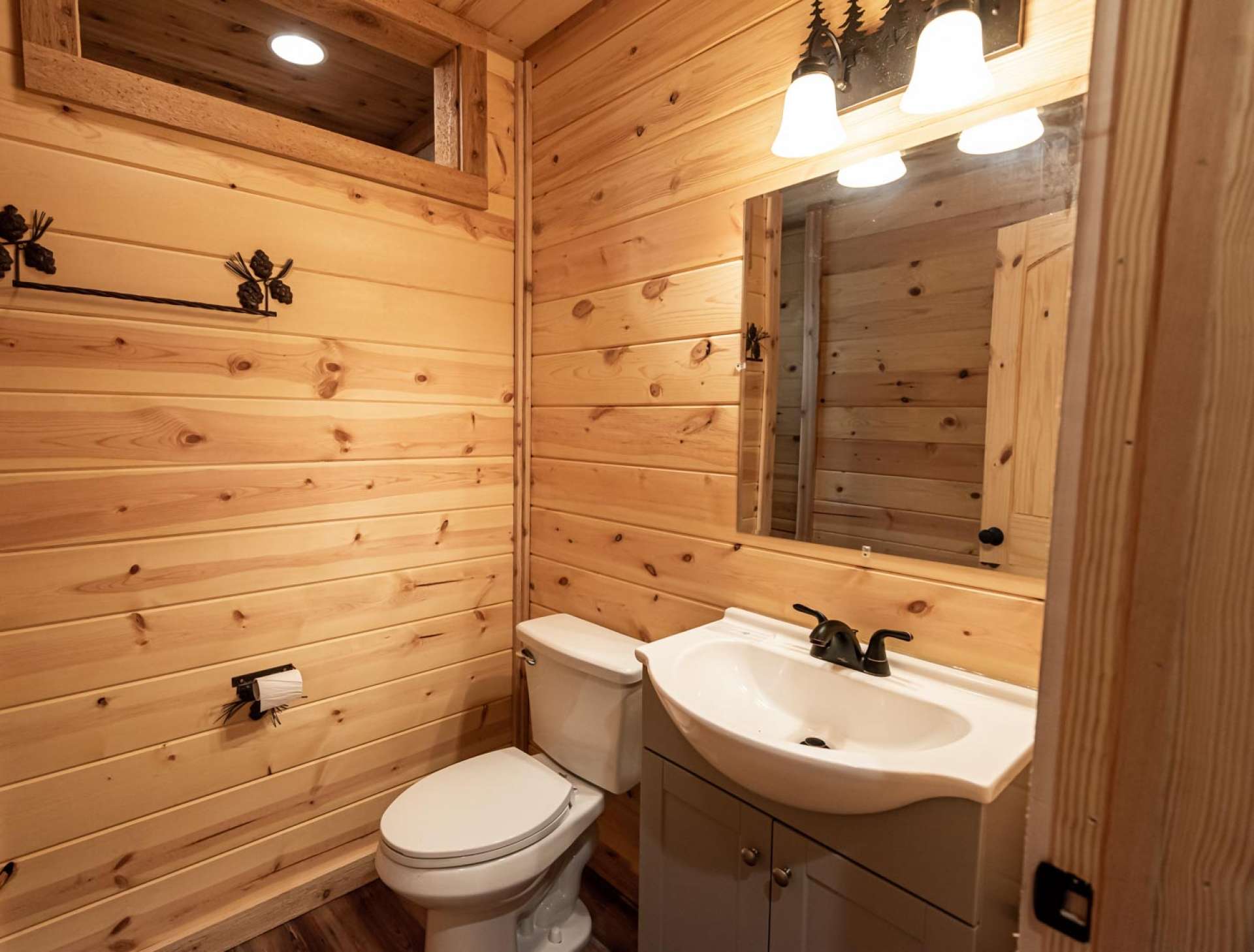 The guest bath in main cabin offers tiled floor.