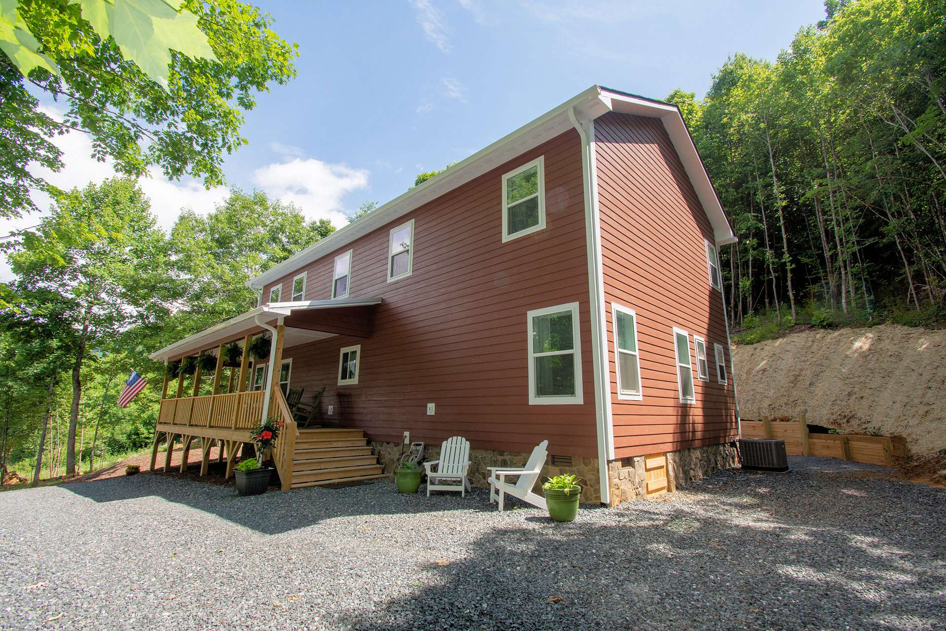 Features include low maintenance fiber cement board siding, stone foundation, architectural shingles with metal roof over the wrap around porch, oak hardwood flooring throughout, custom built cabinetry, stainless appliances, and shiplap siding accent wall in living room.