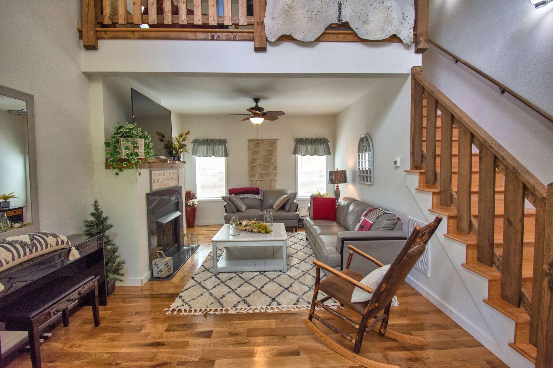 In addition to the inviting gas log fireplace, the living area also offers access to the outdoors and lots of windows for natural light.