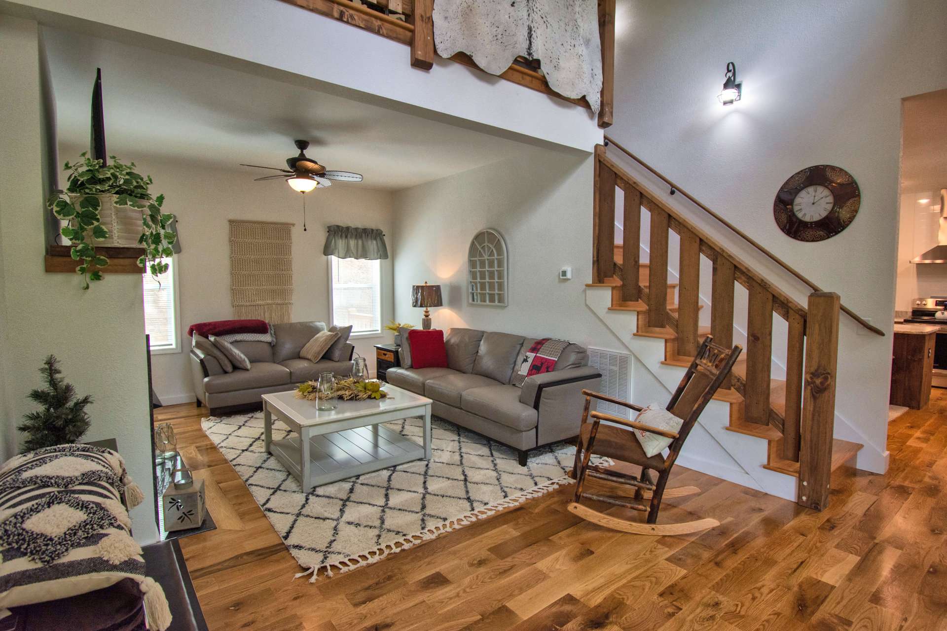 The main level offers the living room with vaulted ceiling, gas fireplace framed in granite, and an open kitchen, dining area including a center island with bar seating  in the kitchen and access to back deck from the dining area.