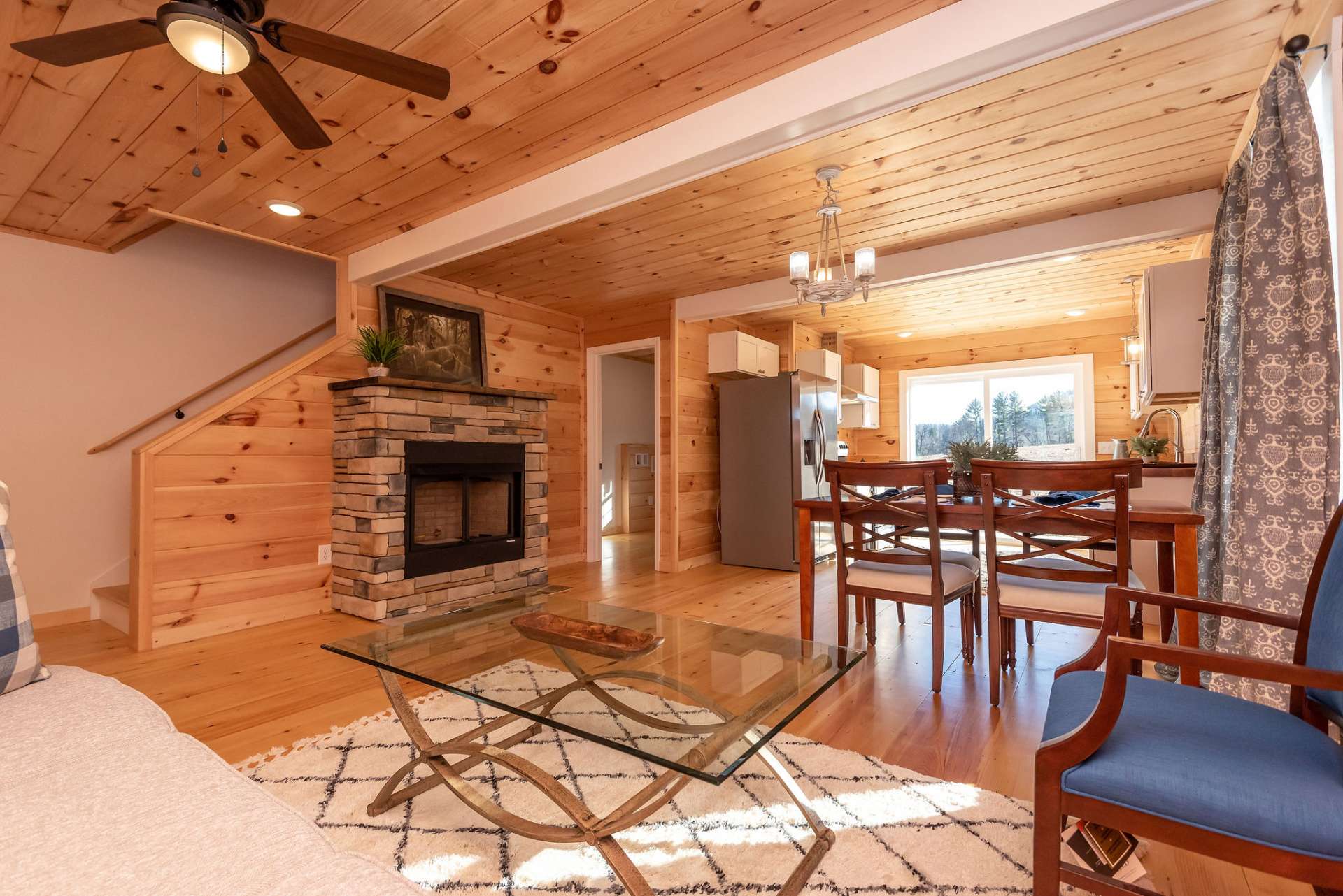 Entering front door into living area looking toward dining & kitchen.