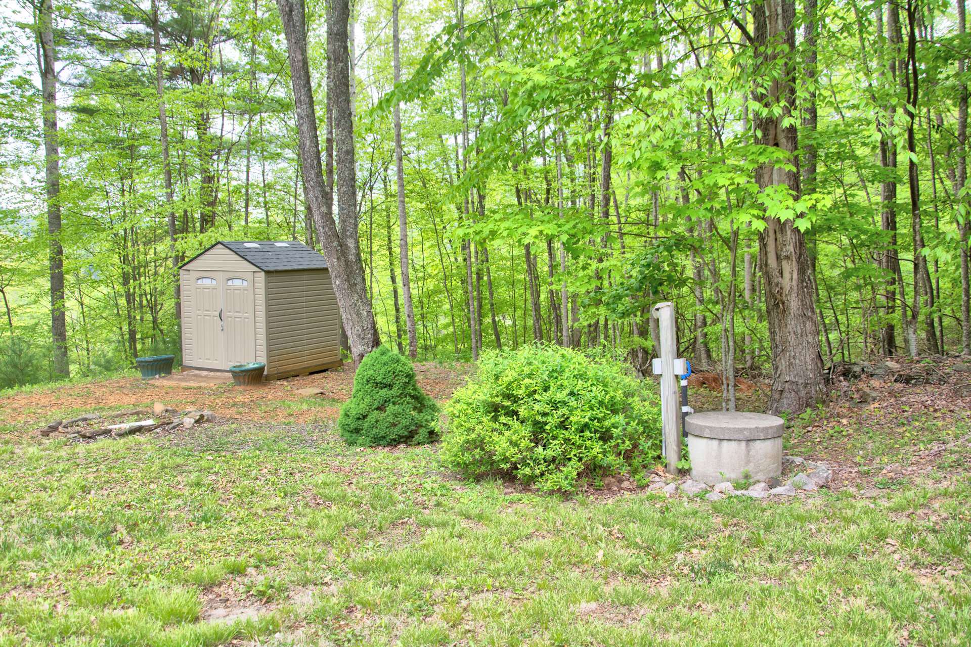 The back yard features a storage building and space for outdoor firepit area.  The location is convenient to the New River, Historic Lansing, shopping in West Jefferson, and hiking at nearby Grayson Highlands Park.