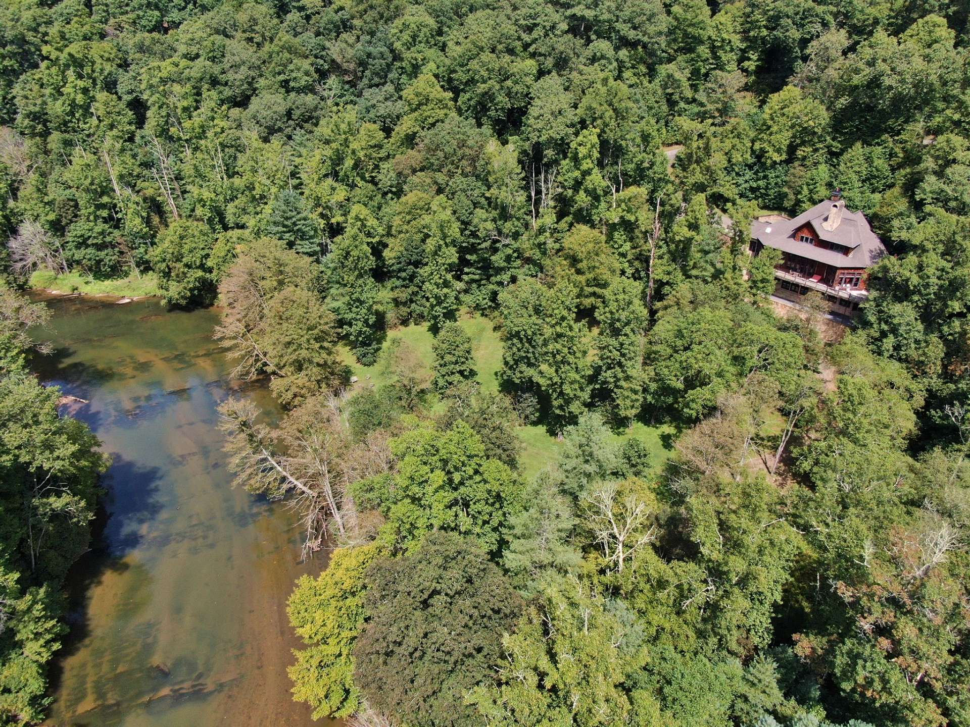 This unique private lodge type property is offered at $1,200,000 and the ideal NC Mountain riverfront estate located in the New River Bluffs community in the Glendale Springs area of Eastern Ashe County.