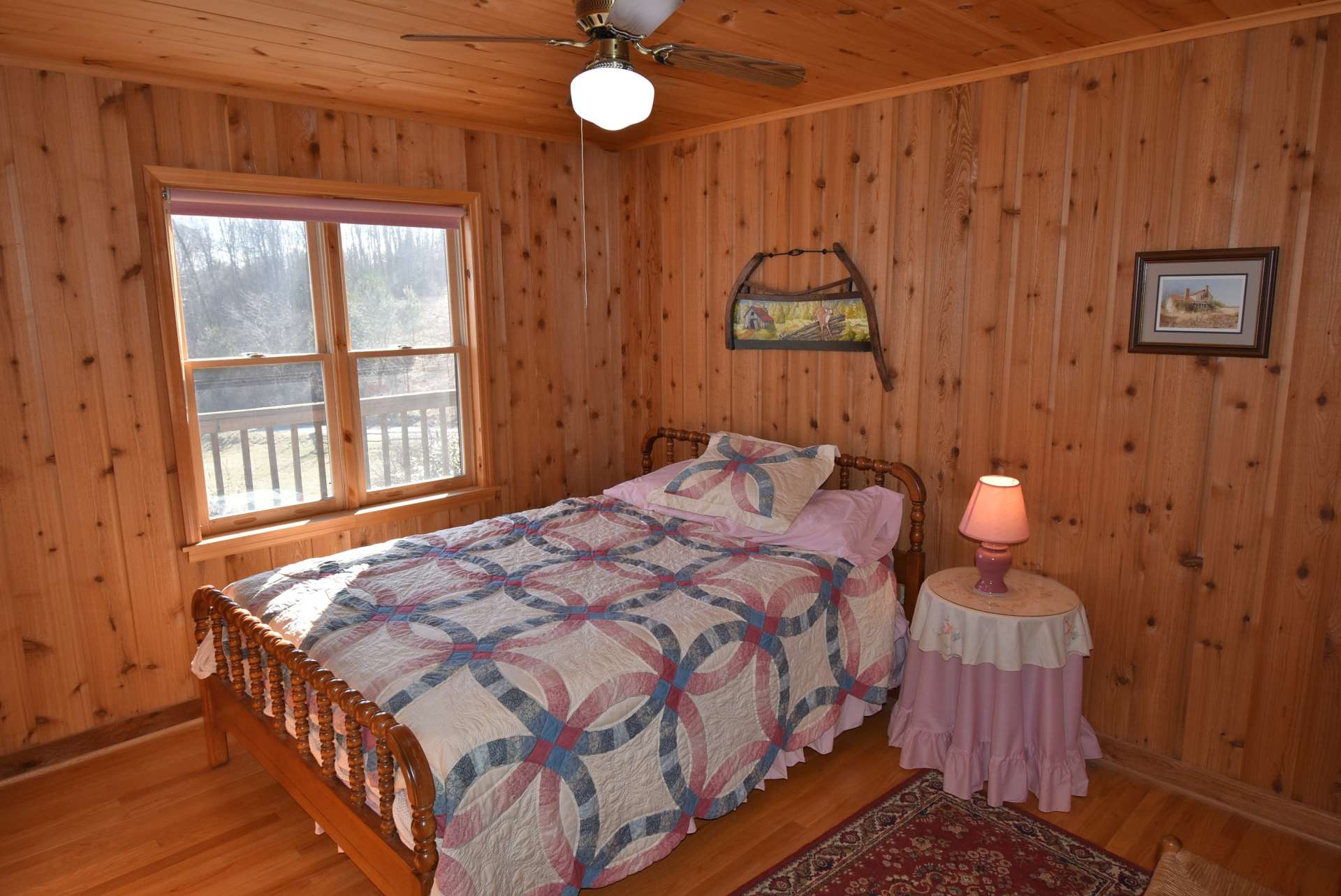 The main level bedroom is spacious and has the rustic country feel.