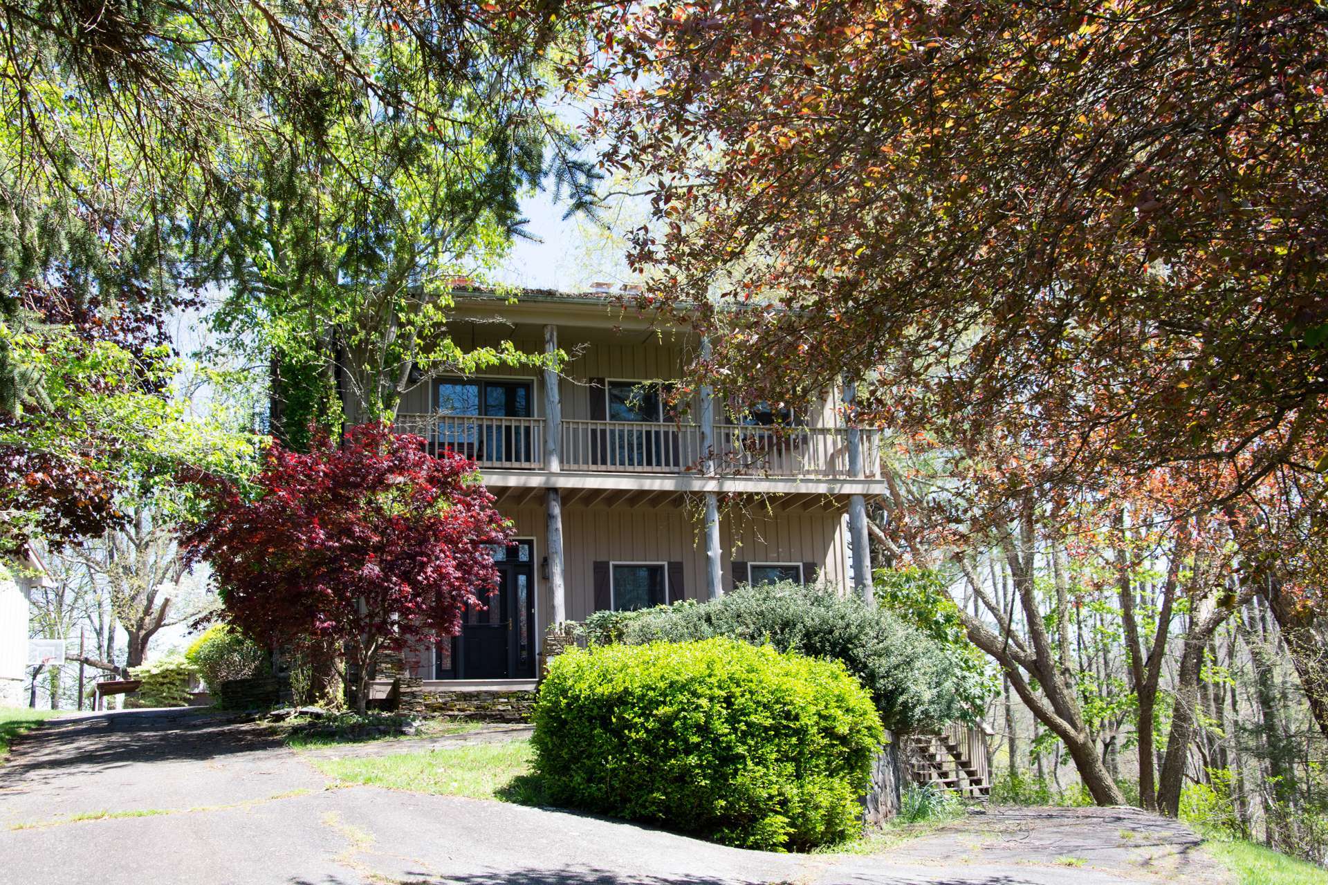 A PLACE WITH SPACE-INSIDE AND OUT! This family-sized home with 4,957 square feet of living space is situated on a mountaintop 18+ acre setting offering complete privacy, plenty of yard space, woodlands for exploring and/or hunting, a bold stream, small goldfish pond, 3-car oversized detached garage, metal storage building, and another shed with garage bays.