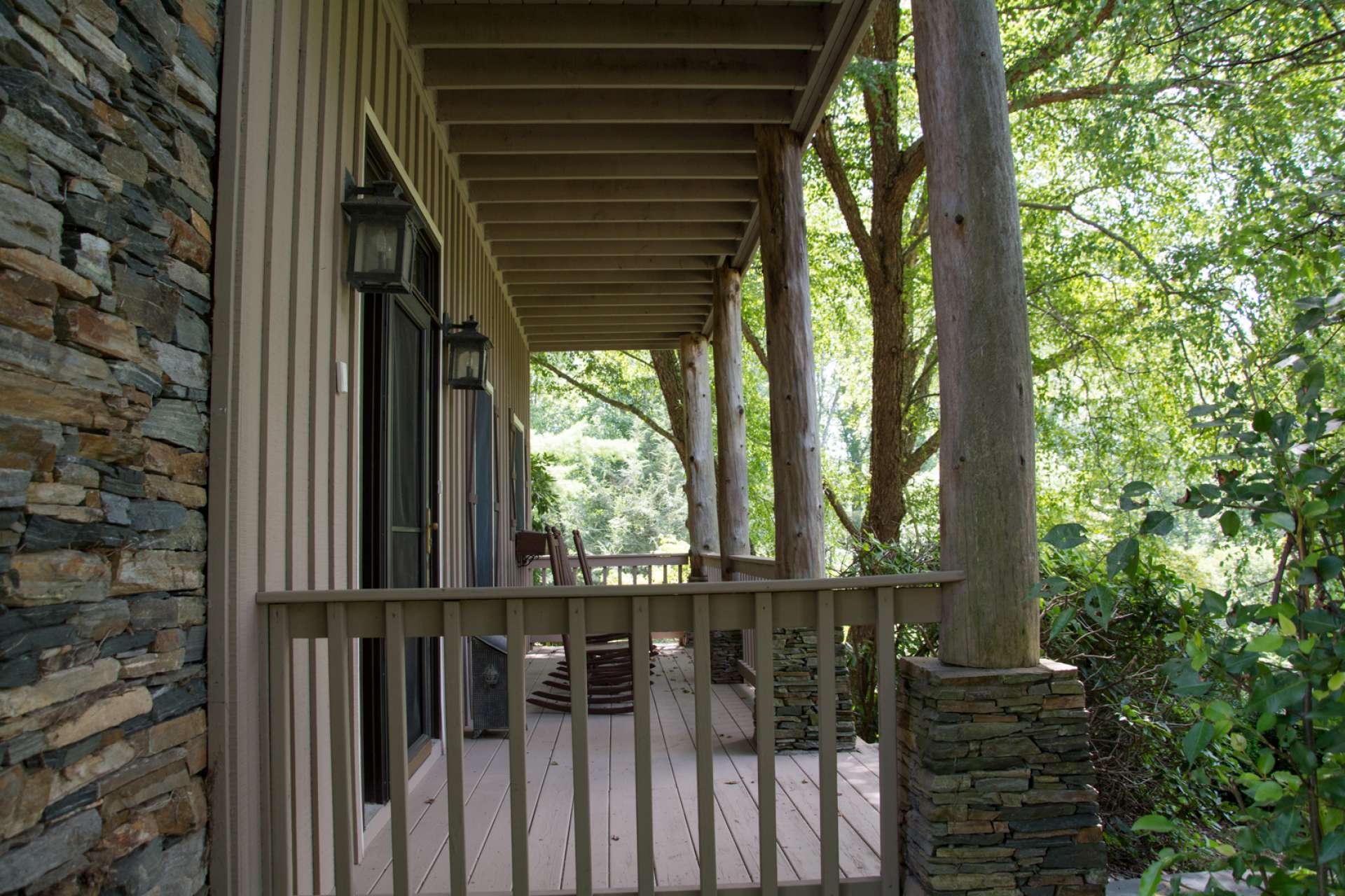 Enjoy multiple outdoor spaces including this covered front porch, upper level balcony, covered side porch, and lots of open outdoor space.