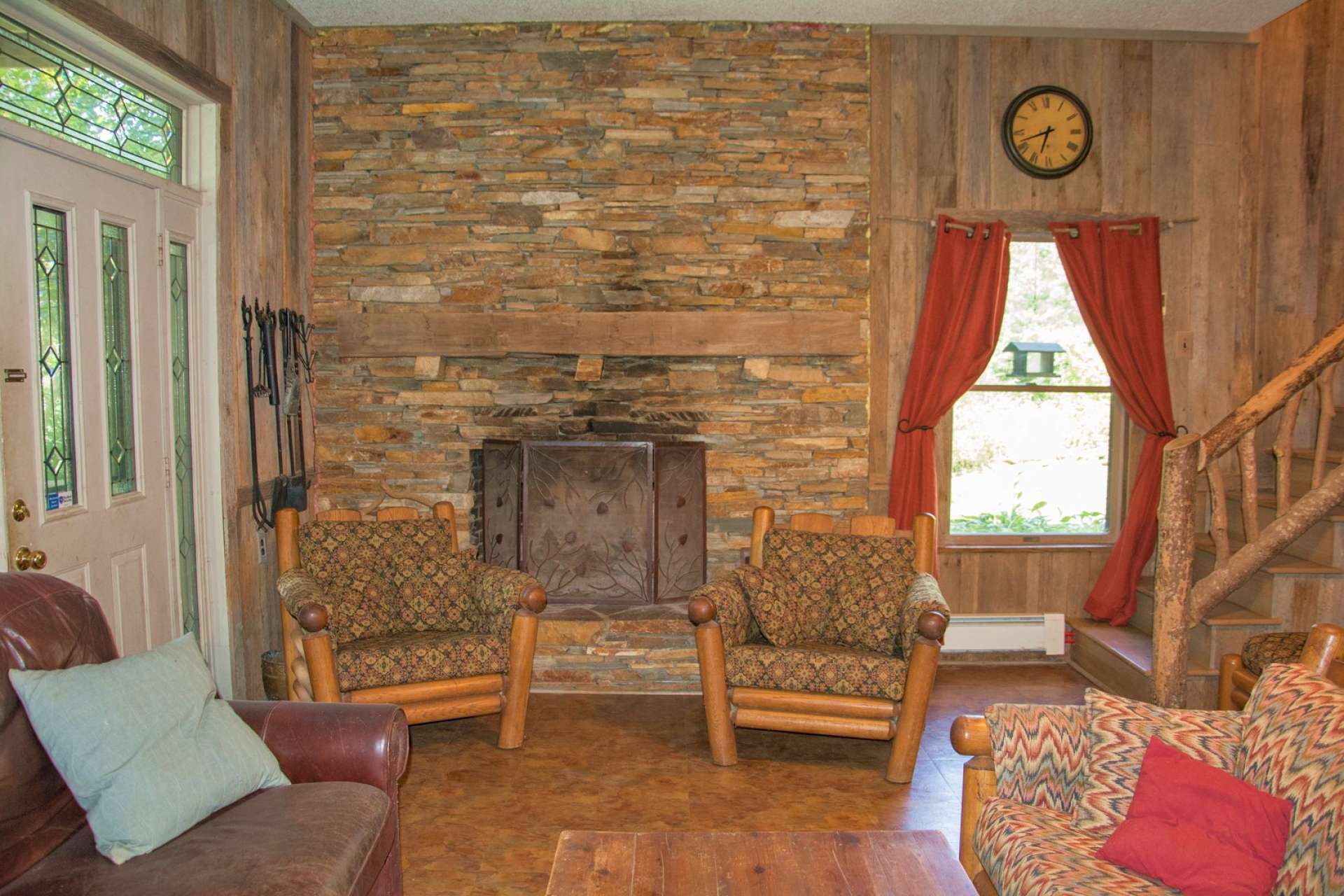 A spacious family room features barn wood accents, stone wood-burning fireplace, and a wet bar for those family gatherings.