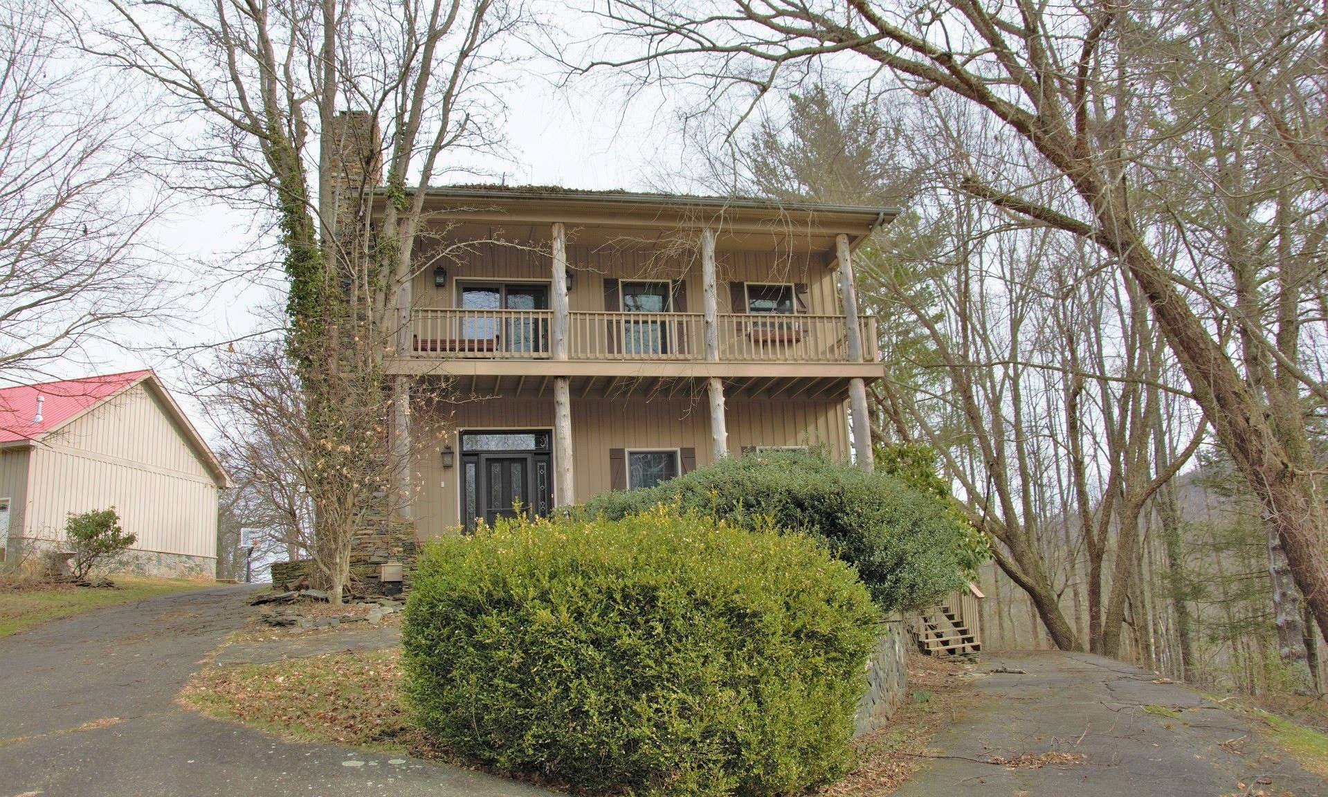 A PLACE WITH SPACE-INSIDE AND OUT! This family-sized home with 4,957 square feet of living space is situated on a mountaintop 35+ acre setting offering complete privacy, plenty of yard space, woodlands for exploring and/or hunting, a bold stream, small goldfish pond, larger pond, 3-car oversized detached garage, metal storage building, another shed with garage bays, fenced pastures, two barns, one of which has finished living quarters overhead, and a 4.68 acre tract with a former medical office.