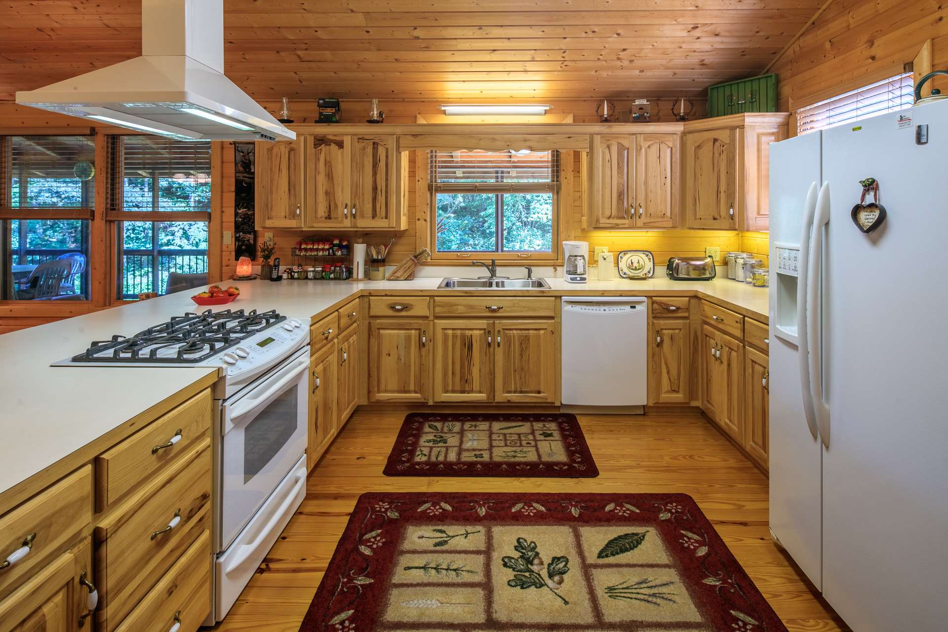 This spacious and well appointed kitchen offers plenty of work and storage space that includes a bar with informal seating.