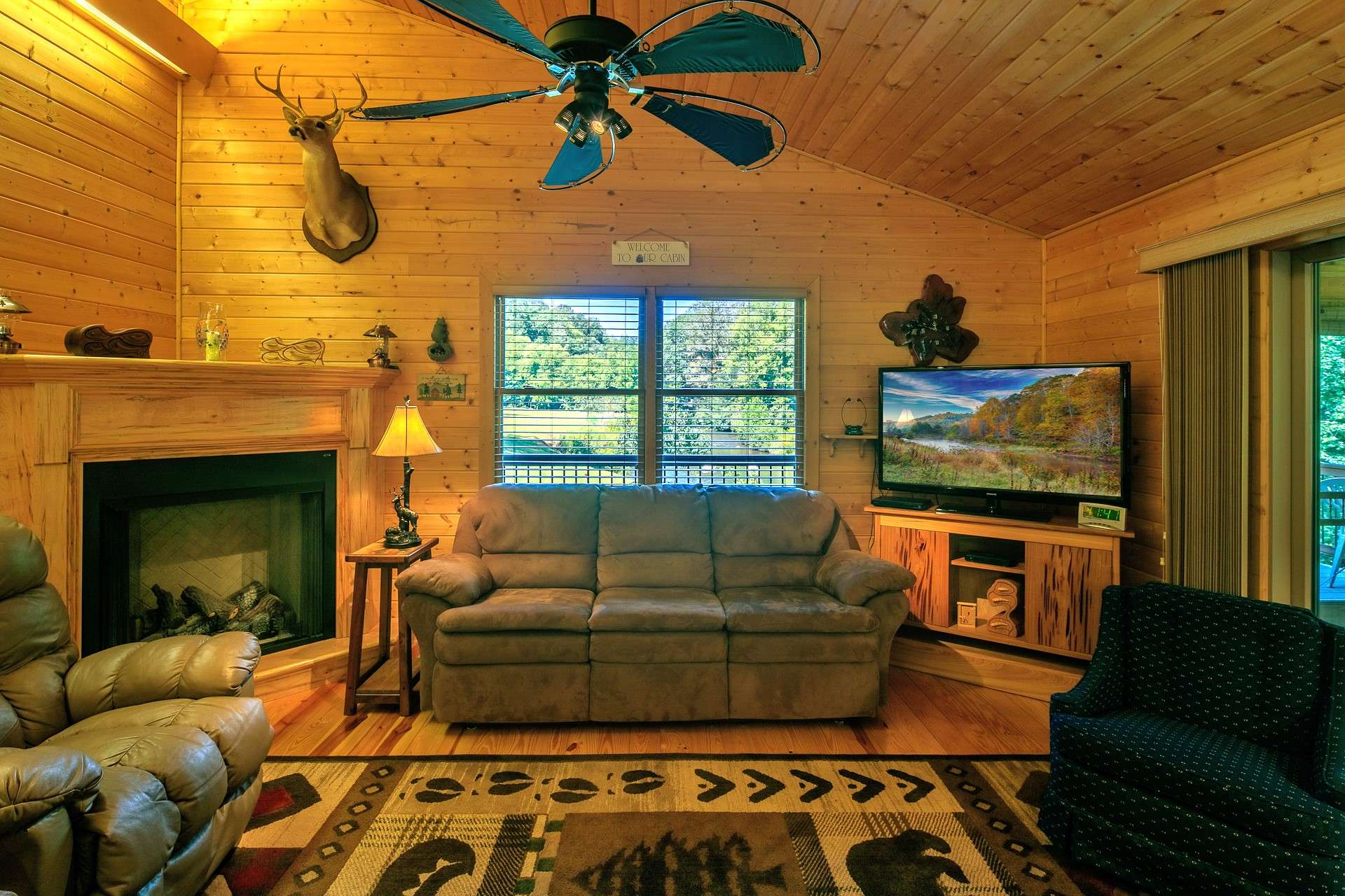 The vaulted ceiling enhances the open feel while the gas log fireplace adds a warm and cozy ambiance to the space.