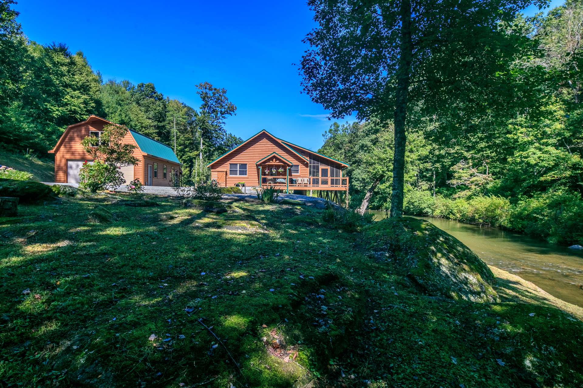 TRULY A RARE FIND!  You will feel like you have your own private park with this 2-bedroom, 2-bath cabin nestled among  30+ unrestricted acres with bold trout stream.