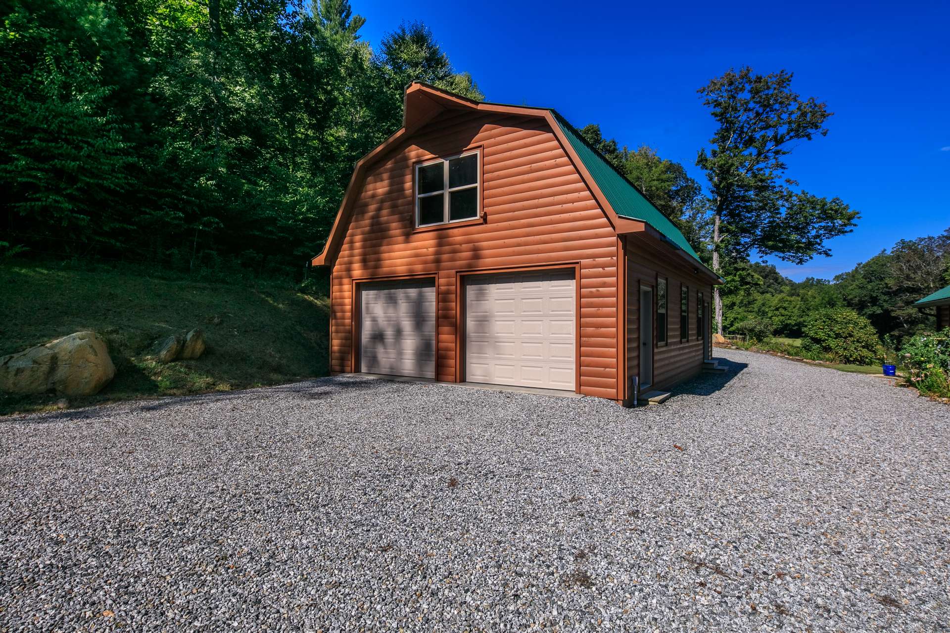 You will appreciate this detached 2-car garage with extended covered storage space for all of your lawn, gardening, and recreational equipment.