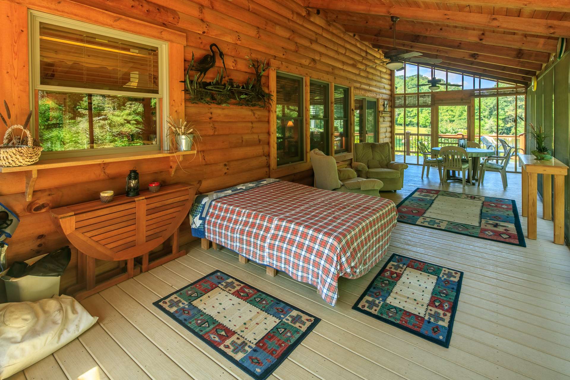 This covered and screened porch expands the living space during the warmer months.  On warm summer evenings you might choose to sleep outside with the sounds of creek below.