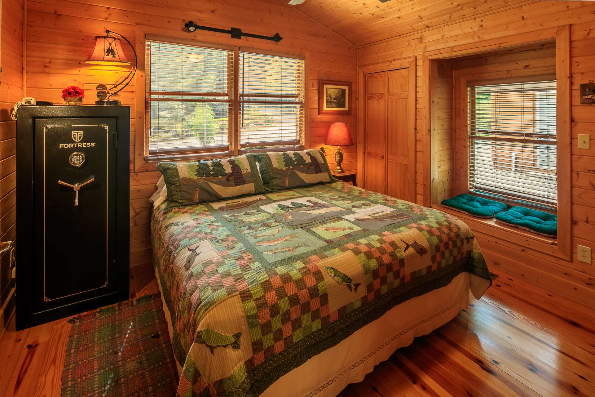 The guest bedroom is generously sized and also offers a vaulted ceiling and plenty of windows.