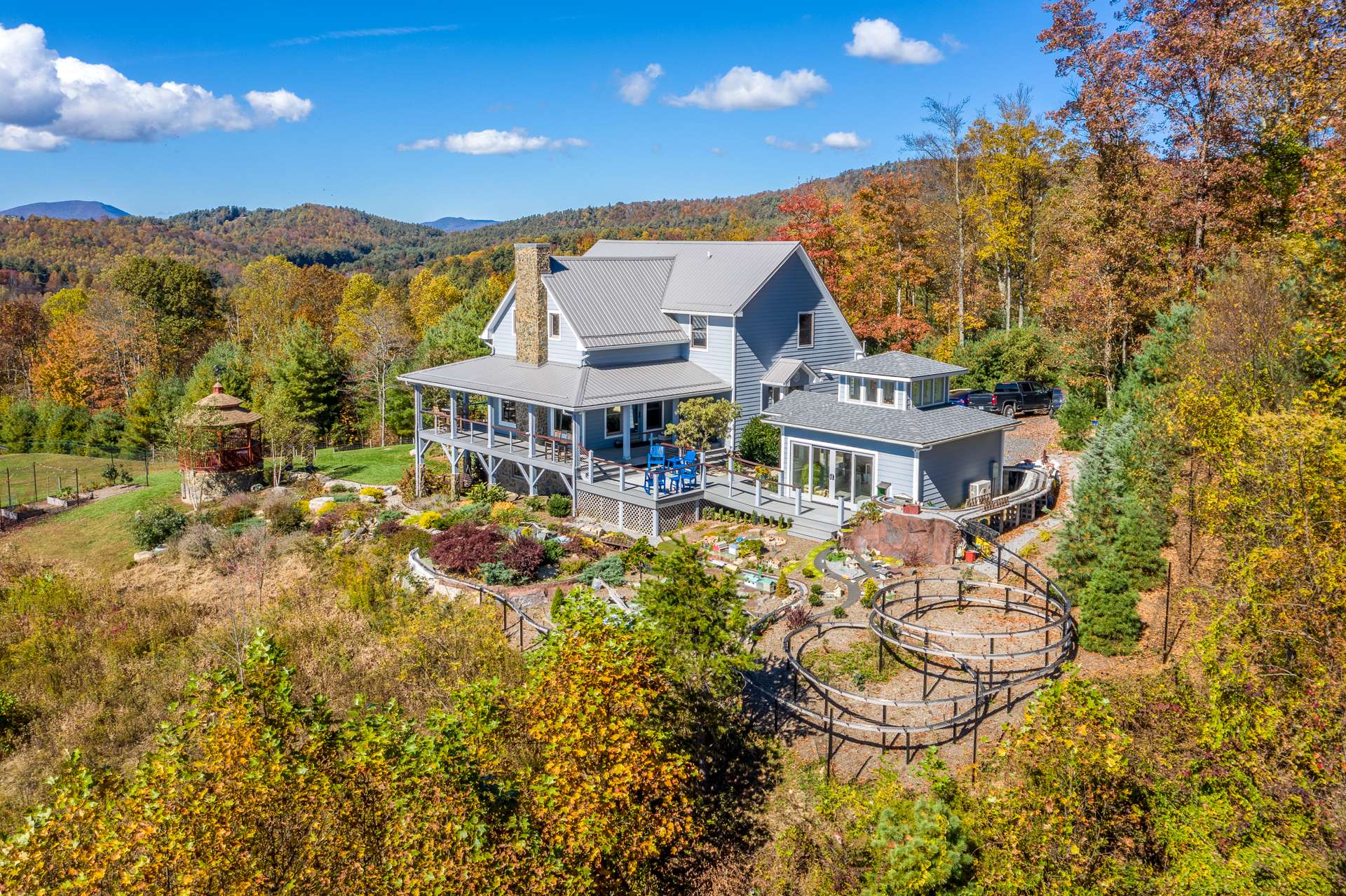 Gated and secluded, this craftsman style home is perched upon a magnificent 24+ acre setting  in the Laurel Springs area of the Blue Ridge  Mountains of North Carolina.