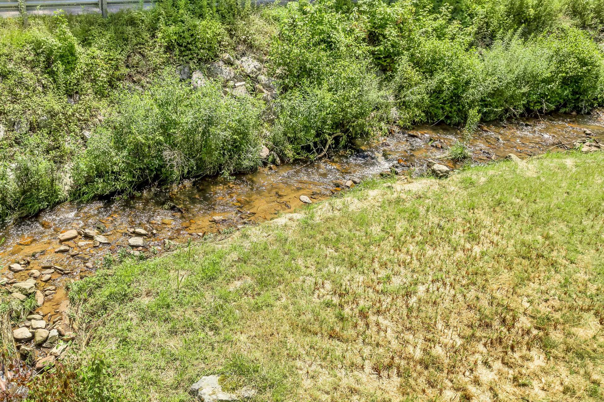 Enjoy its gentle rolls and tumbles as it meanders on its way to the New River. There is a nice garden area here between the creek and the barn.