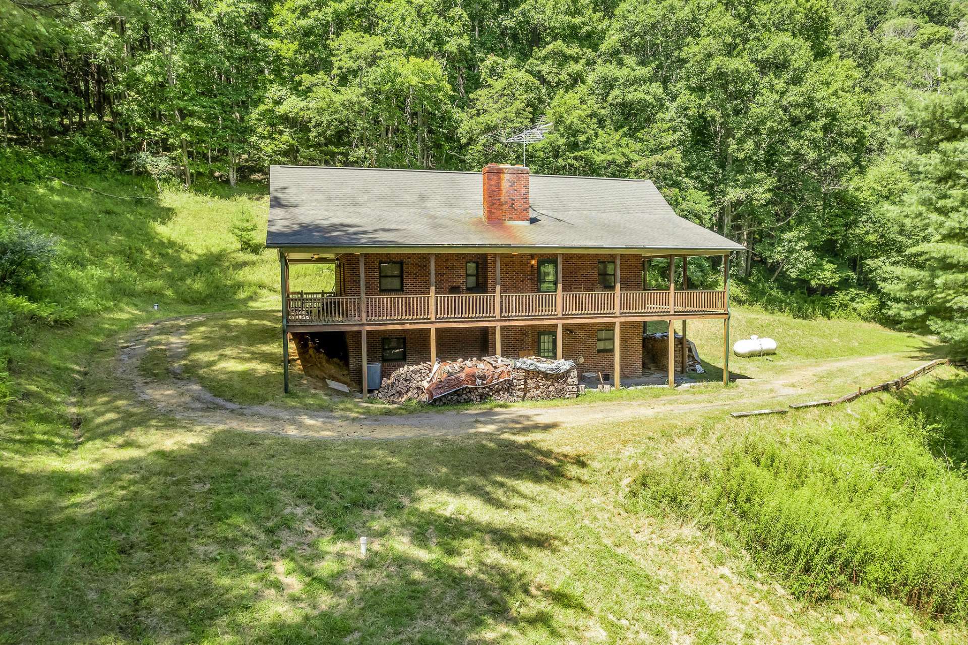 A circle drive brings you home to country comfort in this low maintenance home with a covered porch that wraps around all four sides of the home.