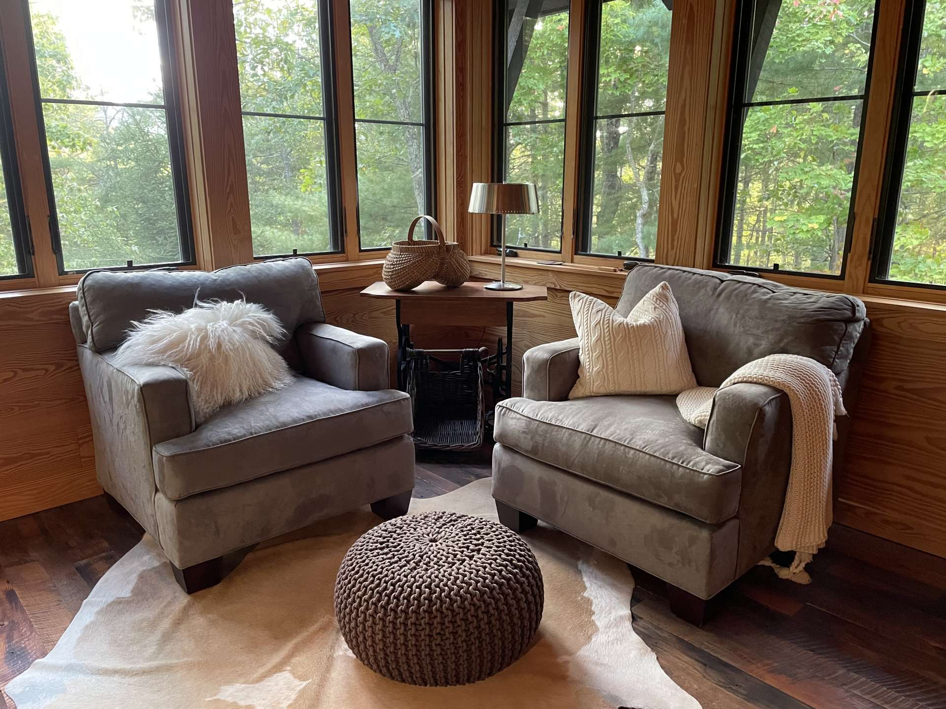 Sitting area in primary bedroom. Walls of windows in primary bedroom.