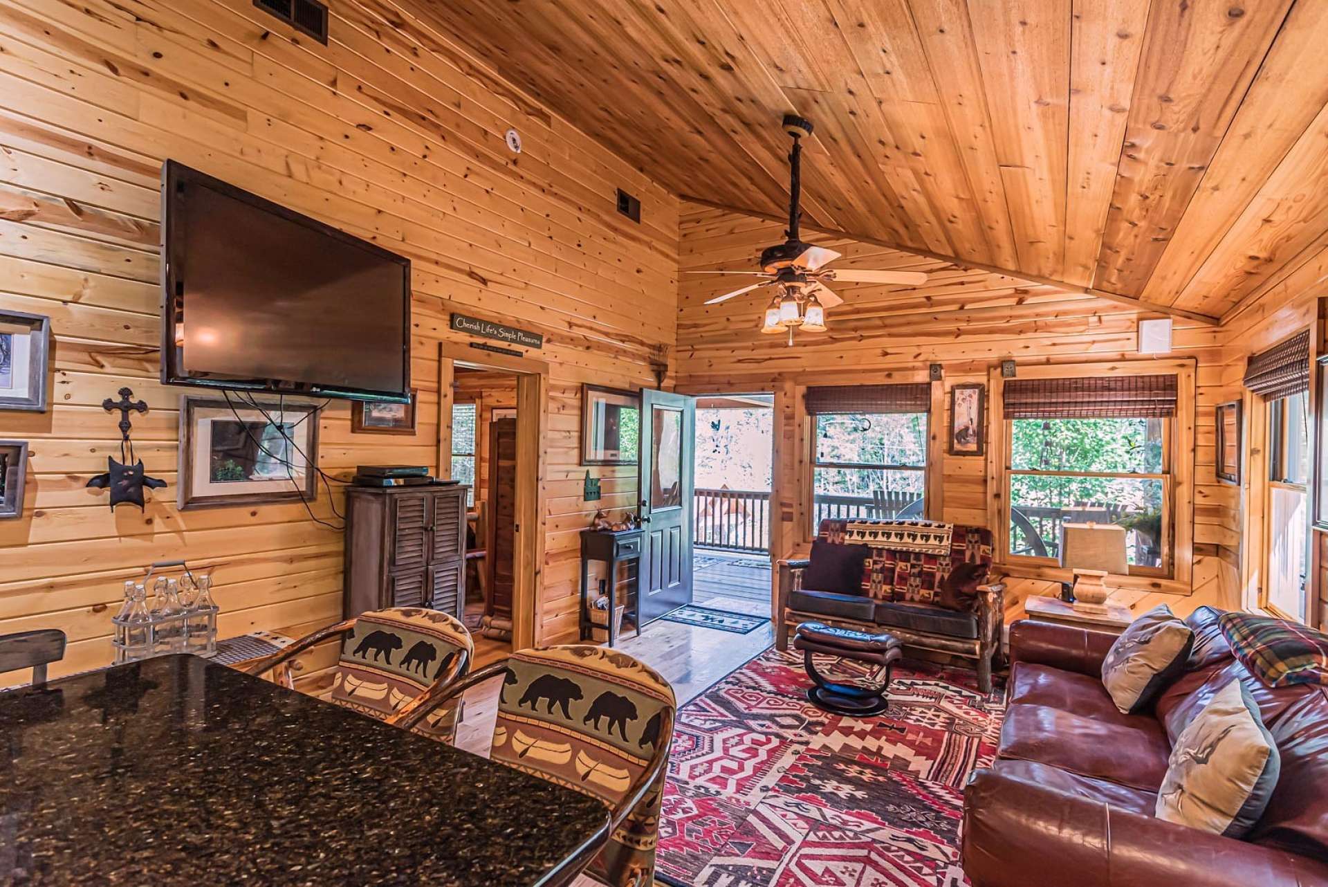 An open floor plan includes a vaulted great room with lots of windows for natural light. This all wood interior enhances the cabin feel and provides for low maintenance care.