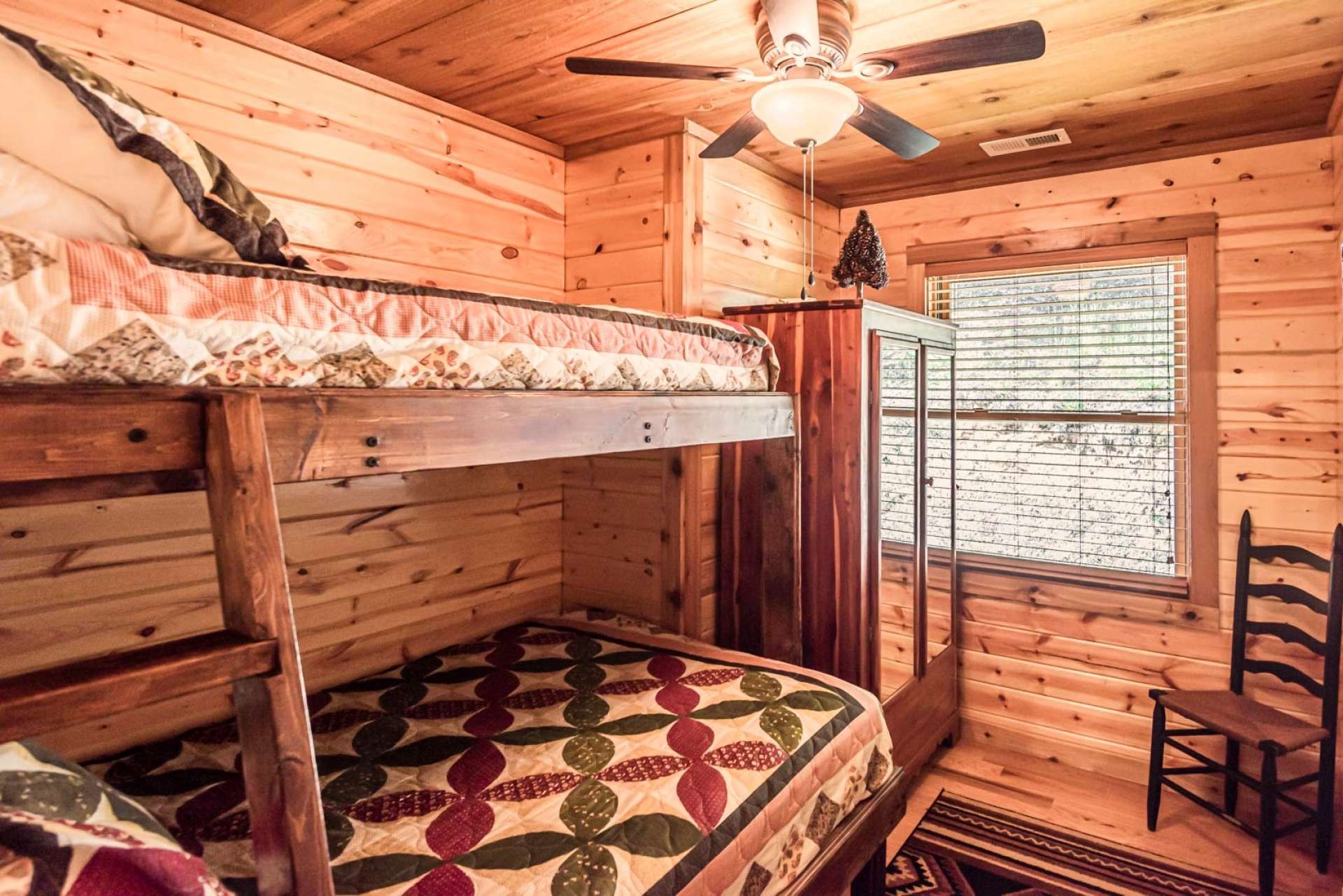 Another main level bedroom offers built-in bunk beds and shares a hallway full bath.