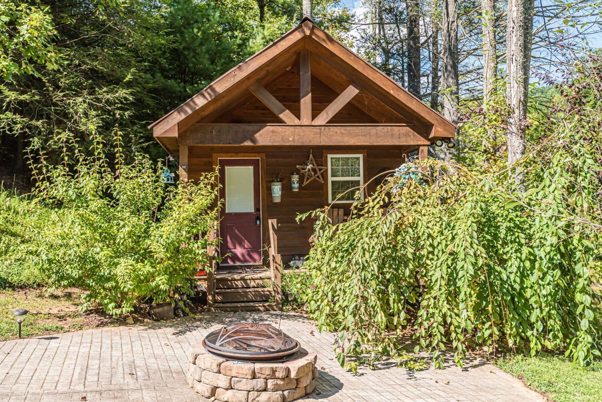 An added bonus is this charming bunkhouse complete with firepit area.