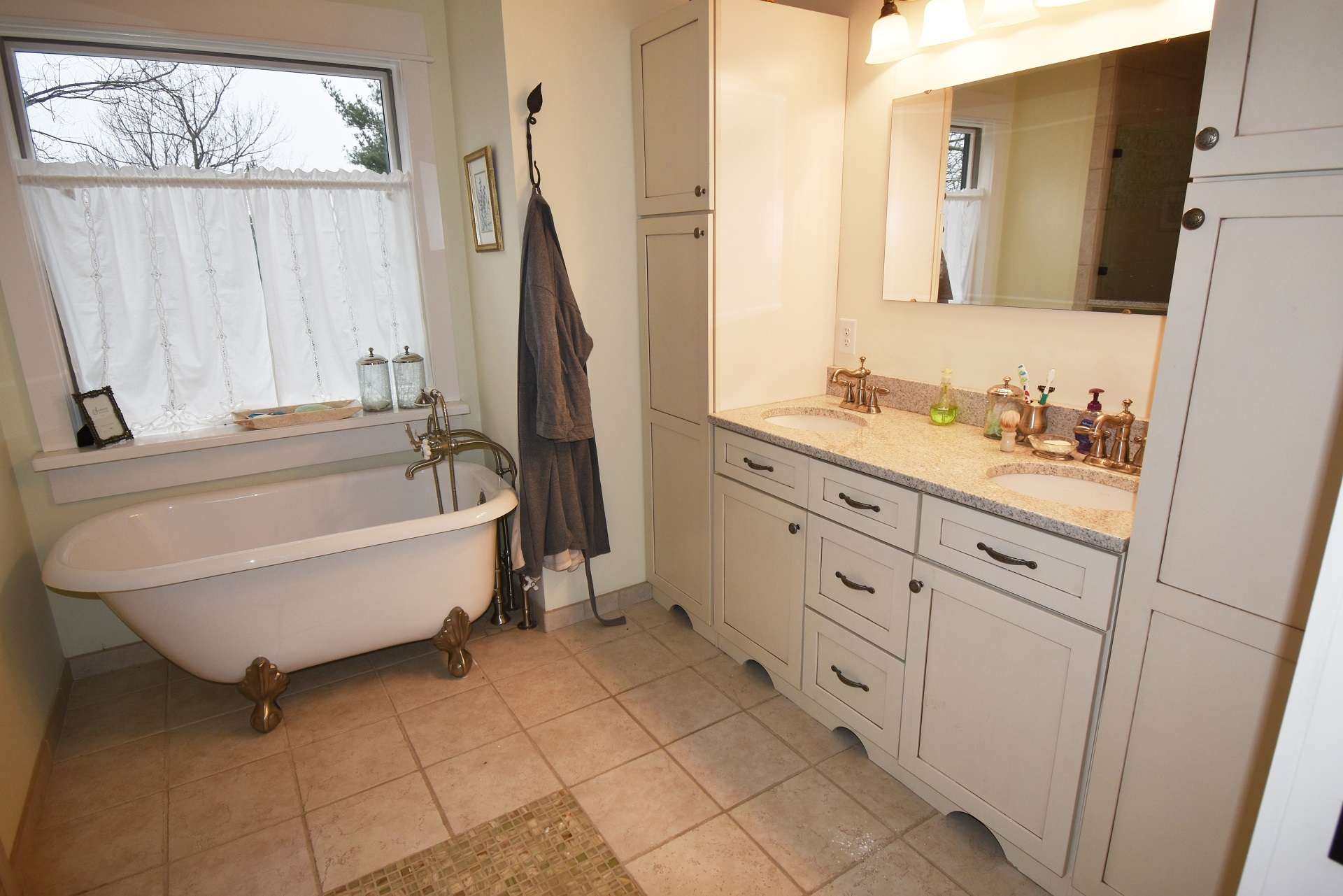 The master bath offers a double vanity, claw foot tub, separate tiled shower and radiant heated floor.