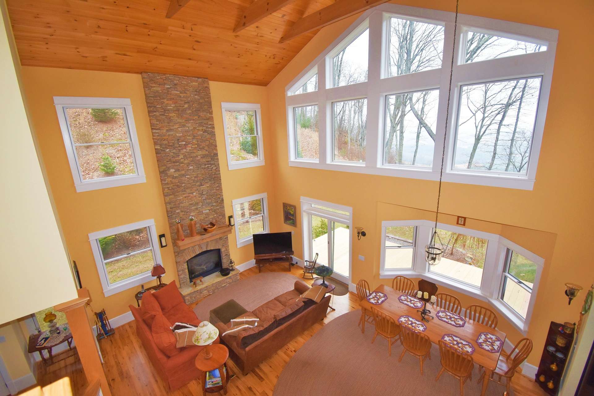 If you enjoy contemporary drama, take a look at this impressive 3-bedroom, 3-bath home filled with custom details. The vaulted great room features lots of windows for natural light, wood floors and ceiling, and a floor to ceiling stone fireplace with gas logs.