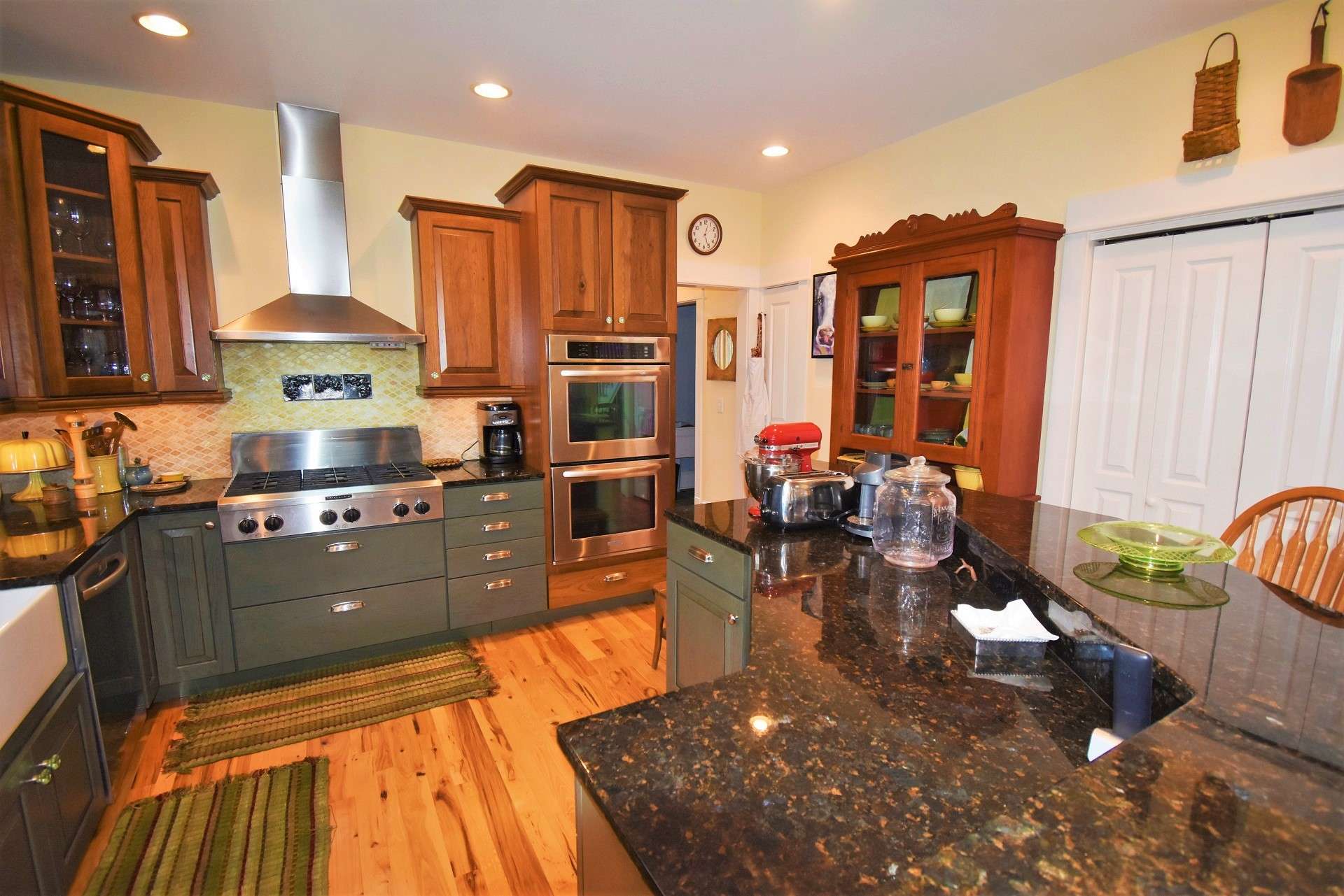 This well planned kitchen is sure to please any chef with its Hickory cabinets, granite counter tops, stainless appliances including a double wall oven with convection oven, farm sink and an island with bar seating.