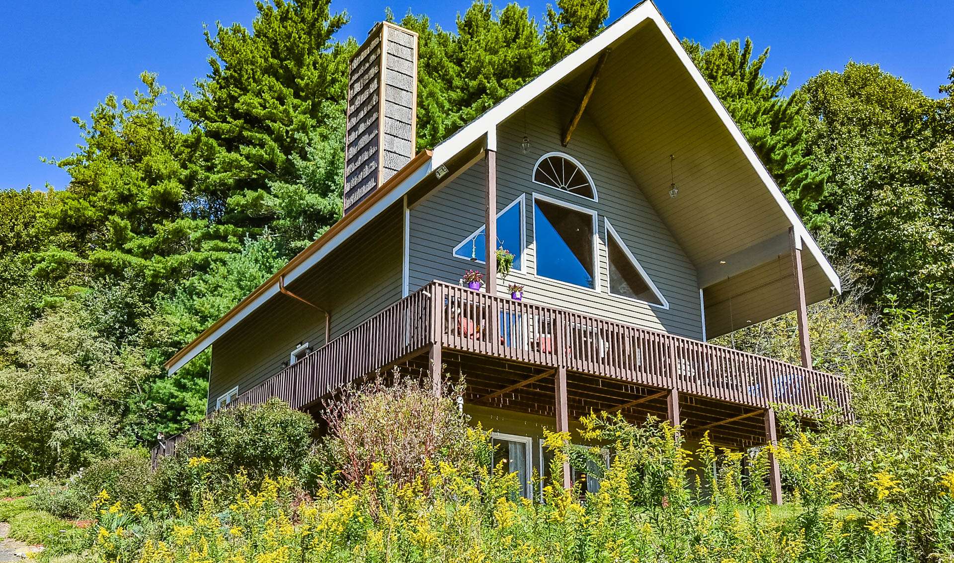 This 2-bedroom, plus two bonus rooms, 3-bath mountain home nestled in a 7+ acre park-like setting just off the Blue Ridge Parkway in the Laurel Springs area of Alleghany County is perfect for your mountain retreat or primary residence.