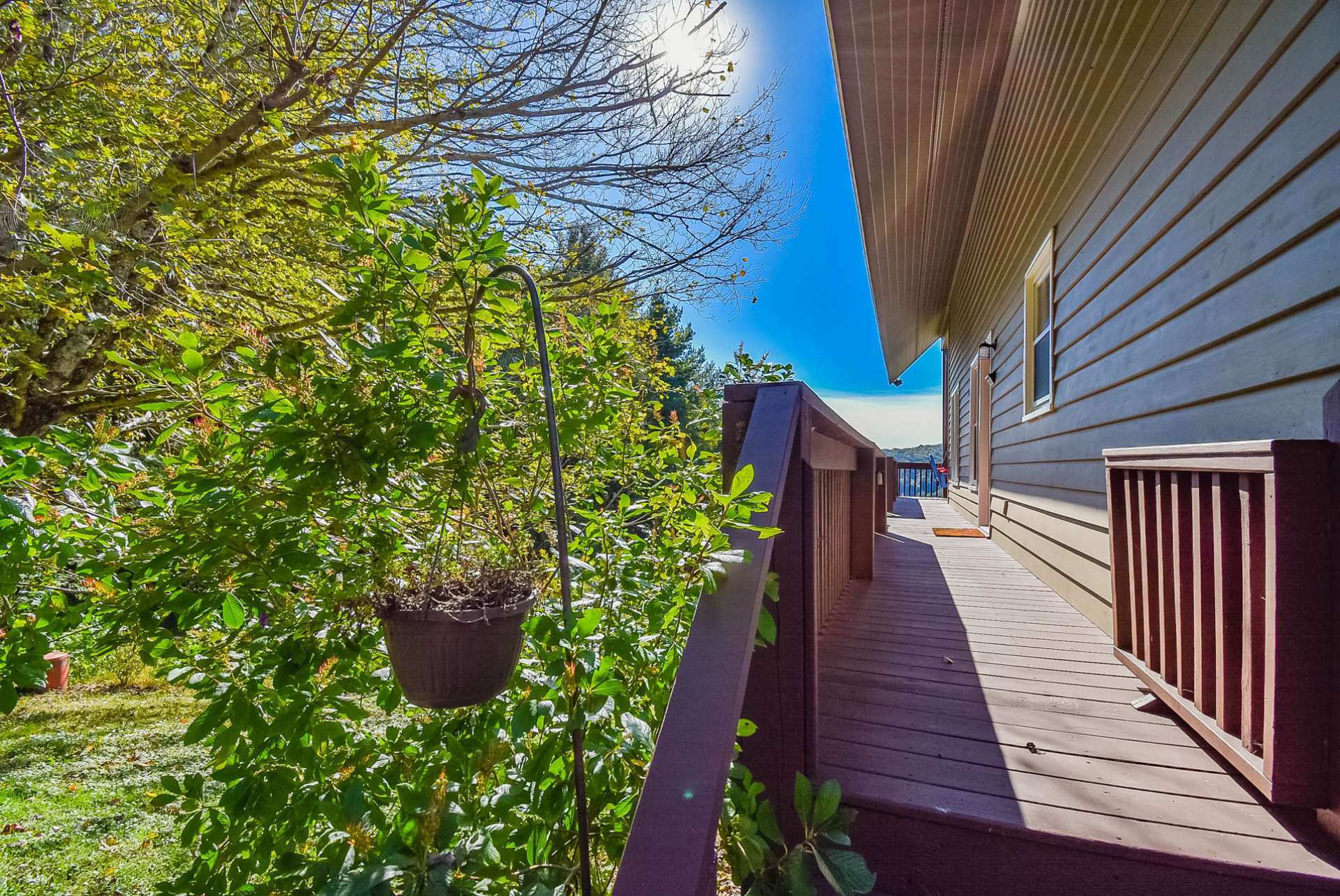 A partially covered deck wraps around three sides of the home.
