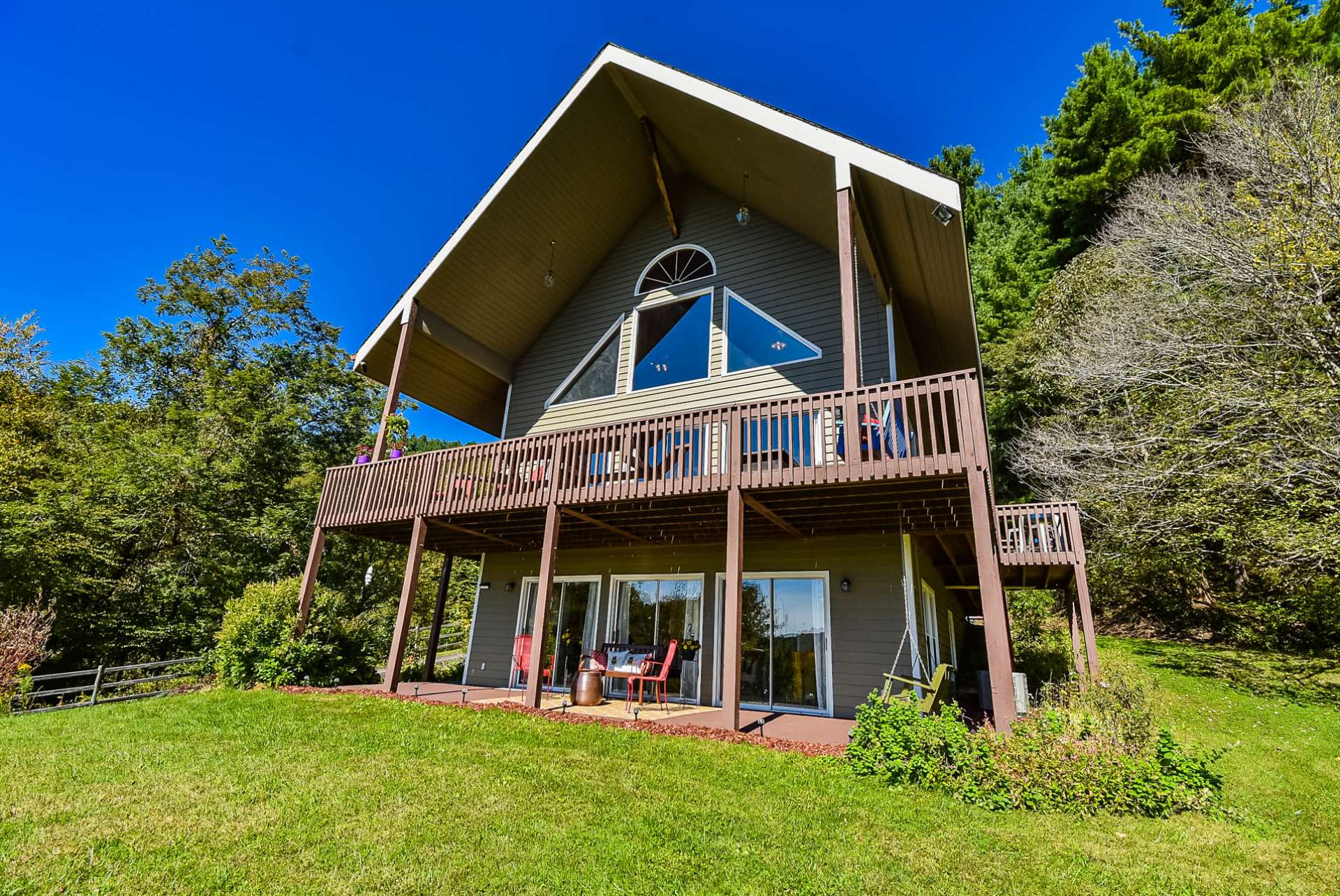 This photo shows the impressive amount of outdoor decking and entertaining space, as well as the open yard space for gardens and play.