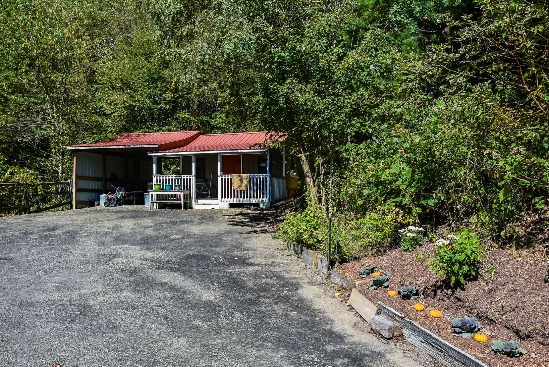 At the end of the driveway is this sweet shed perfect for storing lawn and gardening equipment and/or potting shed.