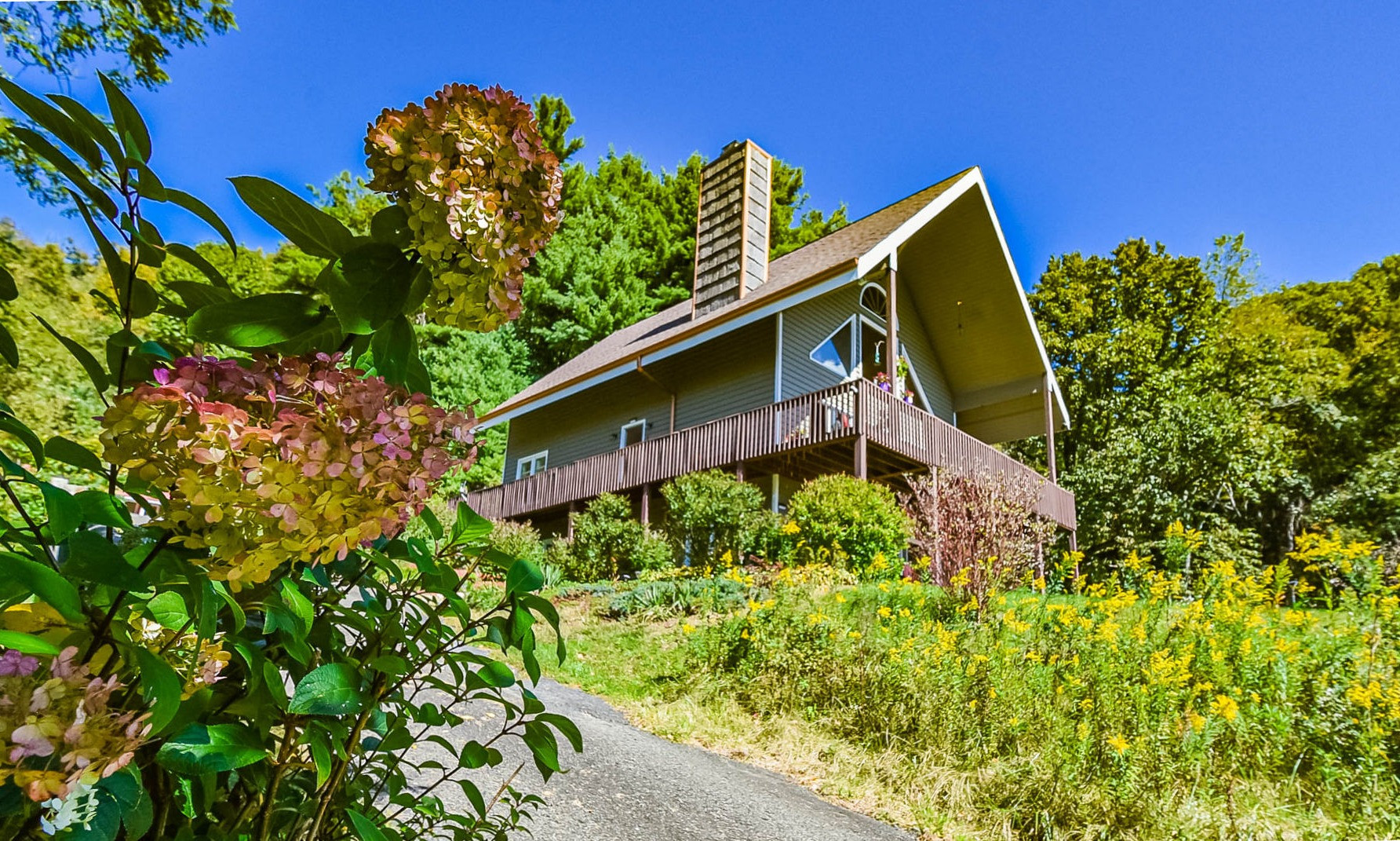 Nestled in a peaceful 7+ acre setting with a small pond, walking trails, abundant wildlife, and a diverse mixture of perennials and wildflowers, this well kept mountain chalet offers a tranquil retreat buffered by Nature.