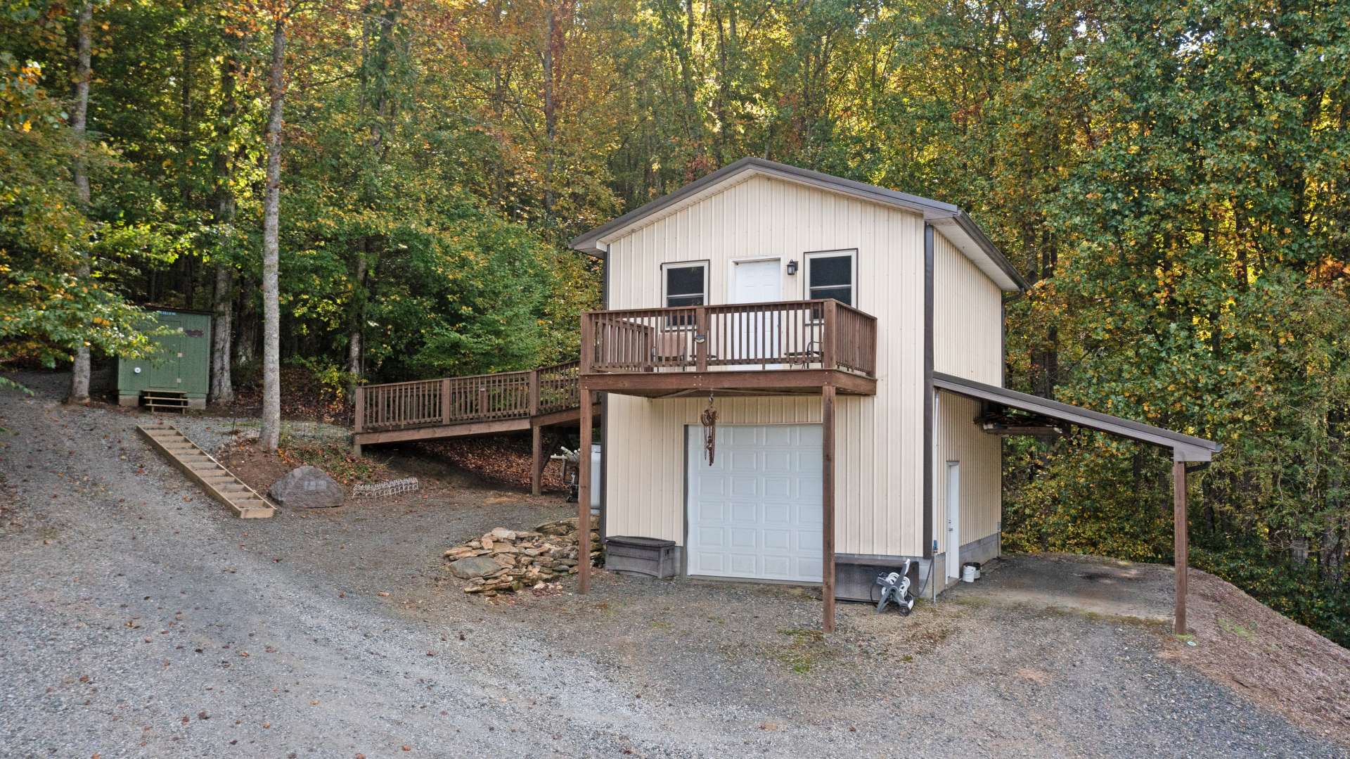 Garage with a game room over and an outhouse with compost toilet