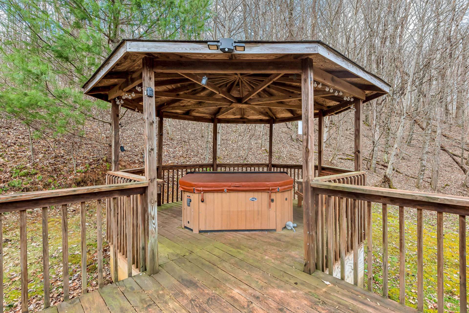 Enjoy a little bubbly in the bubbling hot tub nestled under the sheltering embrace of the back gazebo.