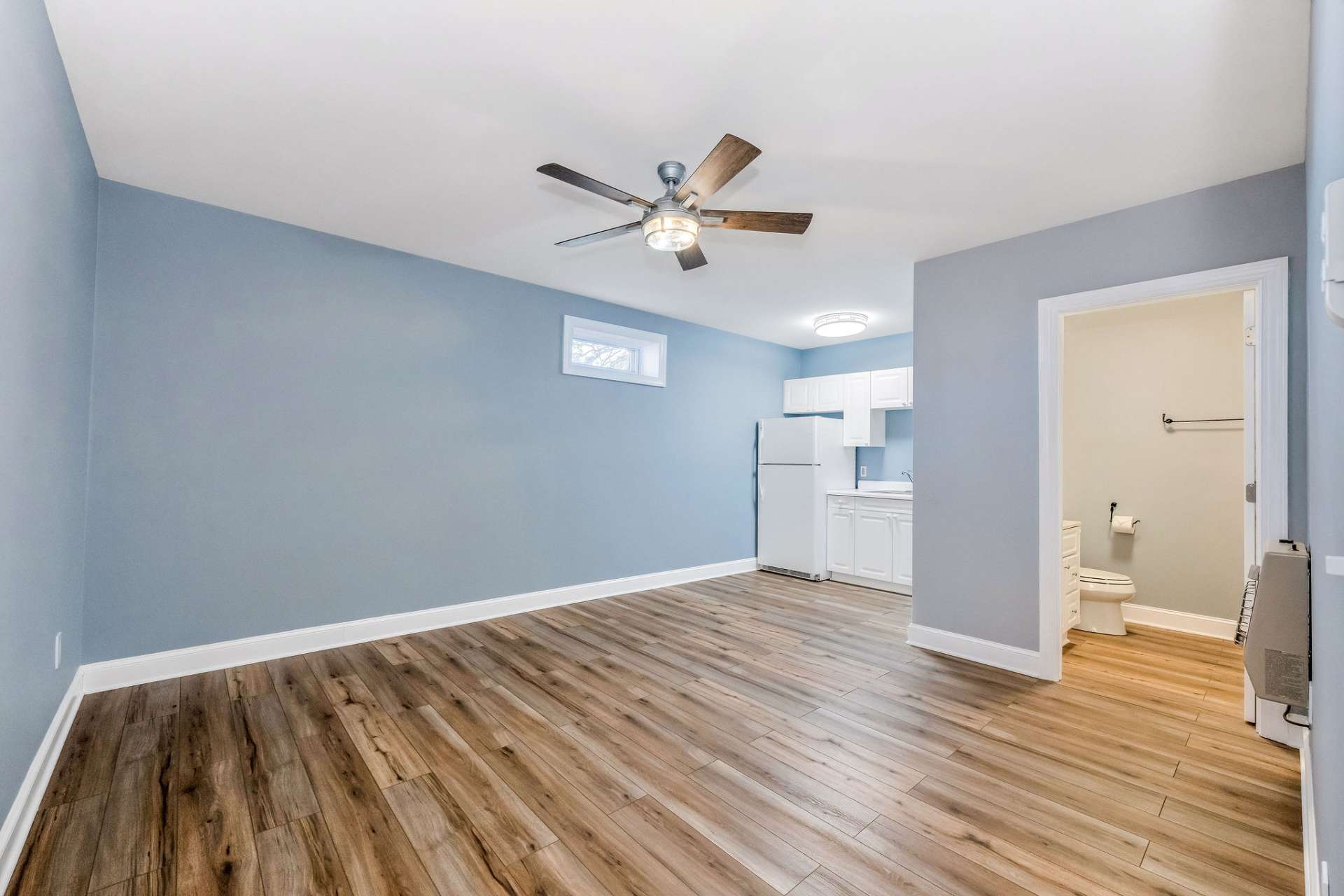 The lower level living space offers a spacious main room featuring a kitchenette.