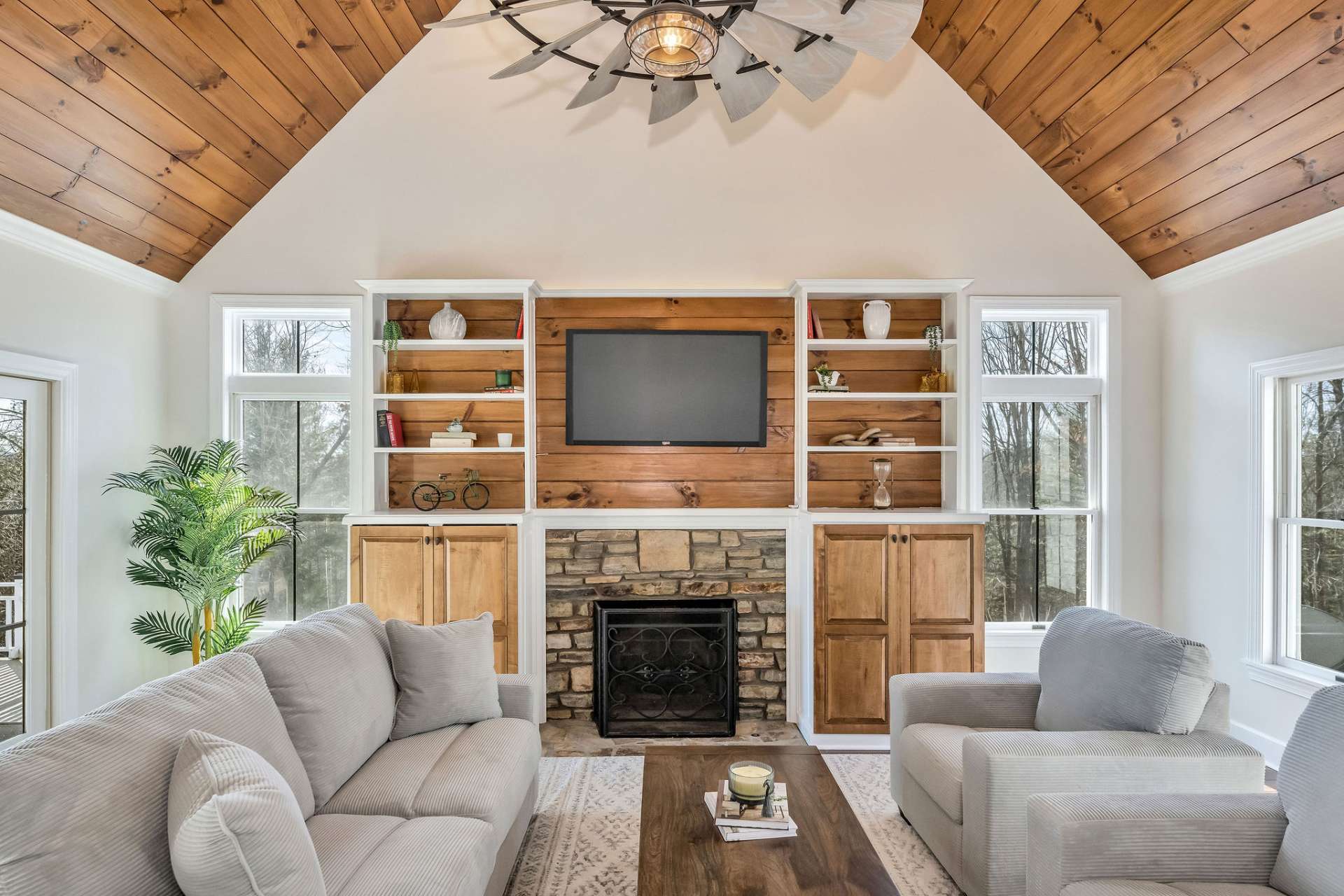 A sunken living room is highlighted by natural wood accents.