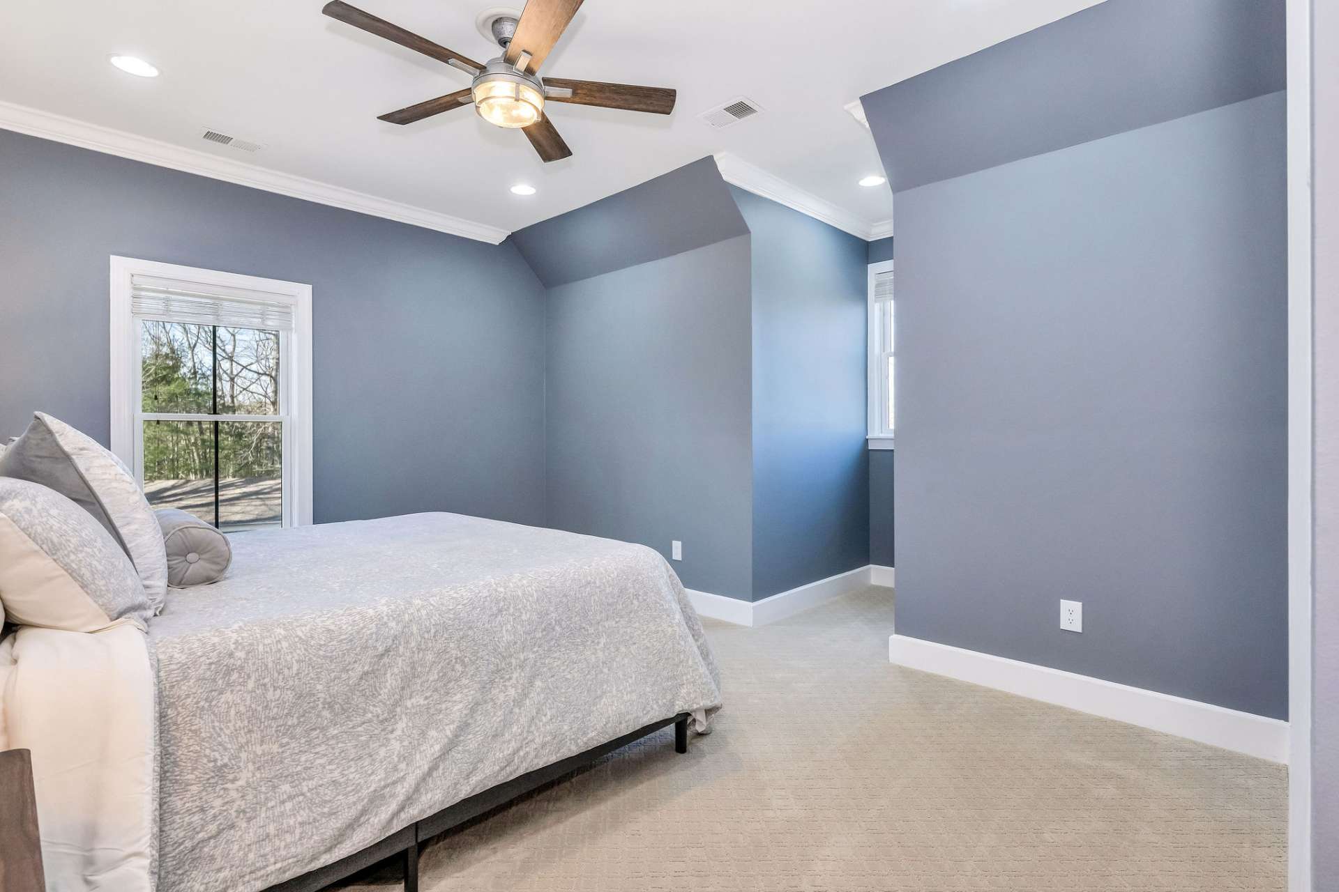 The 3rd upper-level bedroom offers unique charm for family and guests.