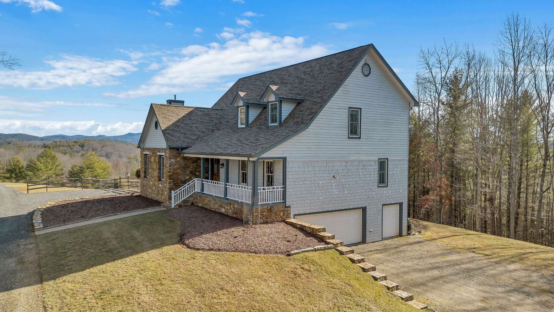 This home is perched high on a knoll with sweeping mountain vistas as the backdrop.